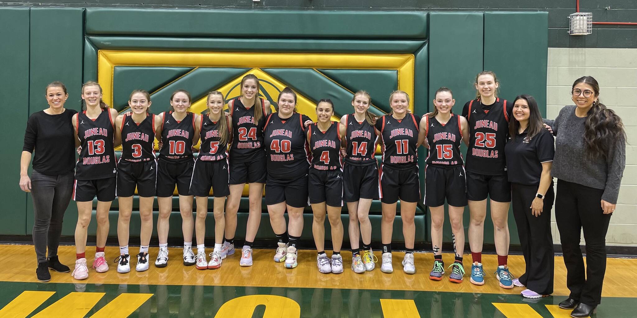 The 2022-2023 JDHS Crimson Bears team with coaches pose for a photo at ASAA state competition in Anchorage on Saturday before competing against TMHS in the championship game. JDHS finished in fourth place and TMHS went home in sixth. (Courtesy Photo / Tanya Nizich)