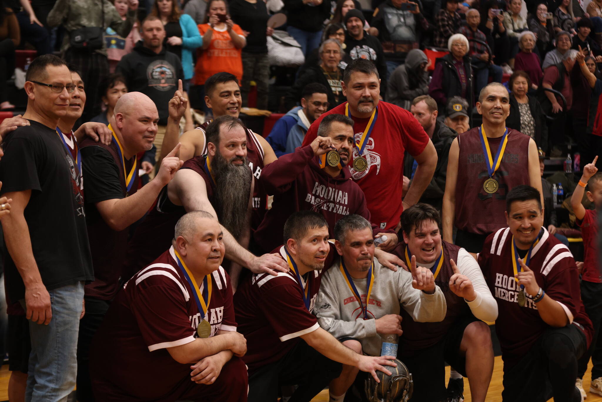 Hoonah’s Masters Bracket team poses for a group photo on Saturday after being crowned this year’s champs for the M bracket in the Gold Medal Basketball Tournament at JDHS. (Ben Hohenstatt / Juneau Empire)