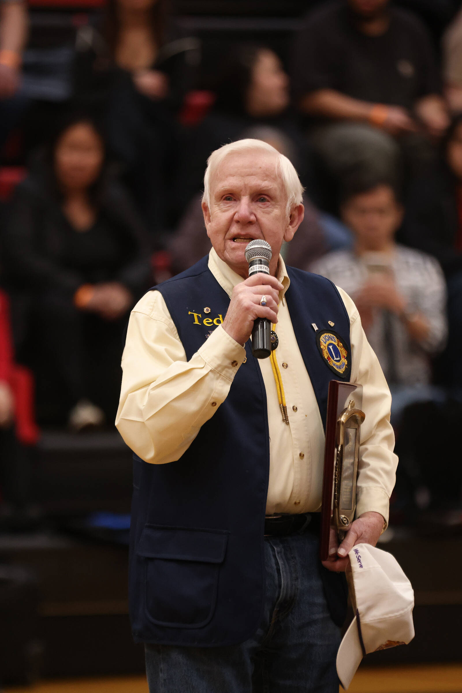 Ted Burke, this year’s recipient of the Dr. Walter Soboleff Award at the Juneau Lions Club 74th Annual Gold Medal Tournament addresses the crowd in the Juneau-Douglas High School: Yadaa.at Kalé gymnasium. (Ben Hohenstatt / Juneau Empire)