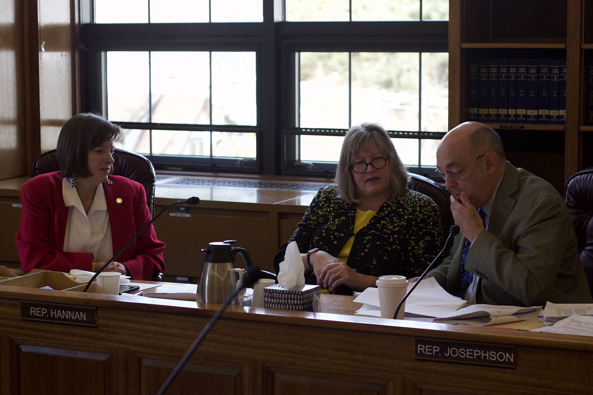 State representatives Alyse Galvin, I-Anchorage, left, Sara Hannan, D-Juneau, and Andy Josephson, D-Anchorage, study proposed amendments to next year’s state budget during a House Finance Committee meeting Tuesday. (Mark Sabbatini / Juneau Empire)