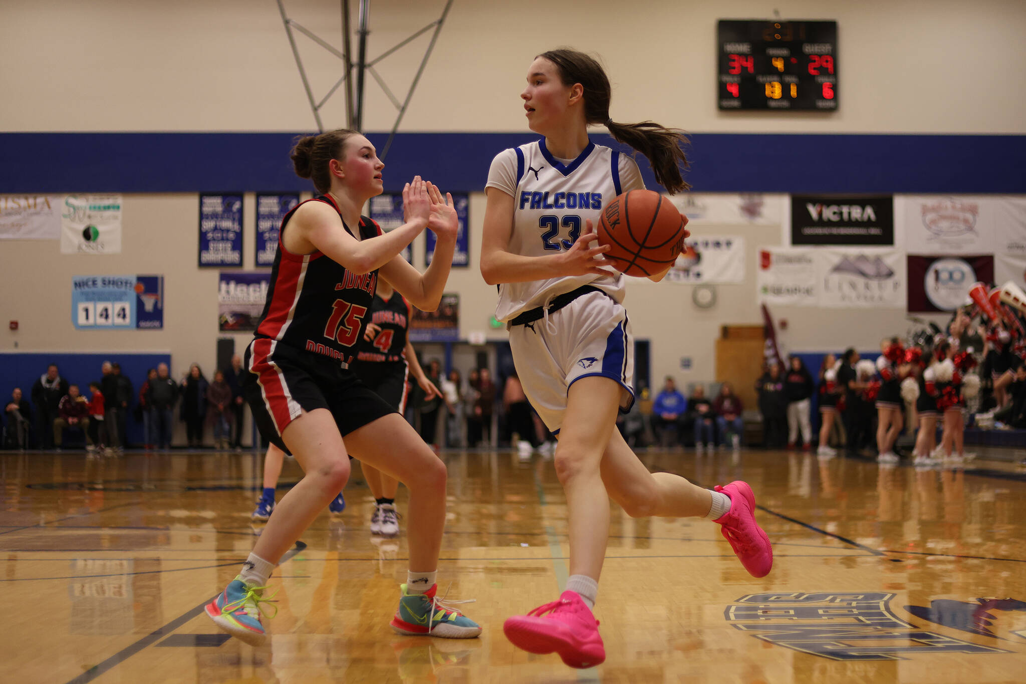 TMHS’ Cailynn Baxter (23) drives while guarded by JDHS’ Gwen Nizich (15) during a Region V Tournament game at TMHS. Baxter earned second team all-state honors for her play this season.