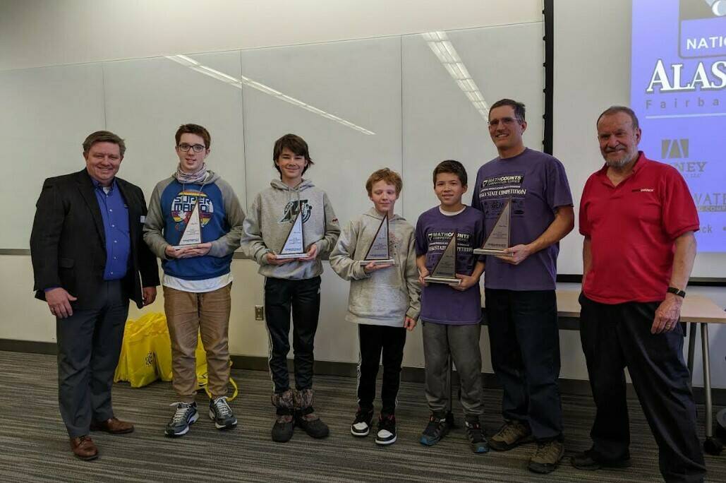(Left to right): Britt Smith, President of the National Engineering Society, Floyd Dryden Middle School team members: Tyler Oudekerk, Caden Morris, Dan Degener, FDMS Coach Alan Degener and State Mathcounts Coordinator Clark Milne. FDMS team receiving their second place trophies at the state Mathcounts tournament in Fairbanks on March 25.