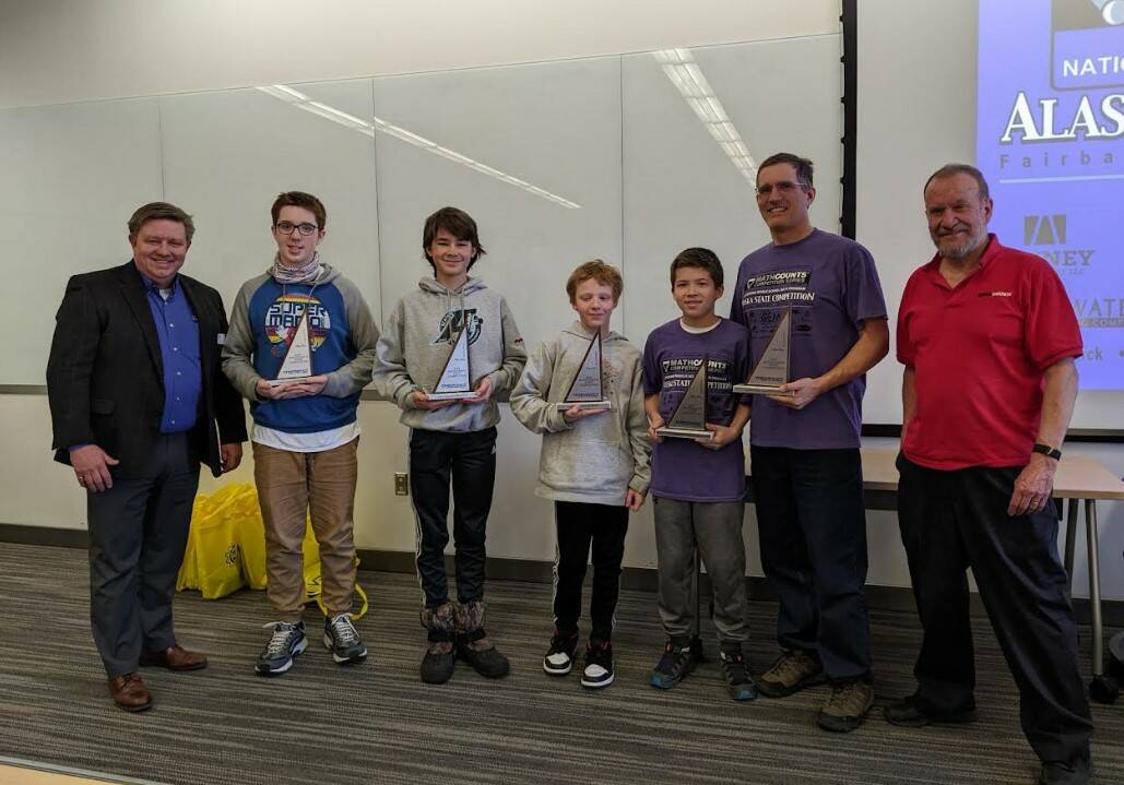 (Left to right): Britt Smith, President of the National Engineering Society, Floyd Dryden Middle School team members: Tyler Oudekerk, Caden Morris, Dan Degener, FDMS Coach Alan Degener and State Mathcounts Coordinator Clark Milne. FDMS team receiving their second place trophies at the state Mathcounts tournament in Fairbanks on March 25.