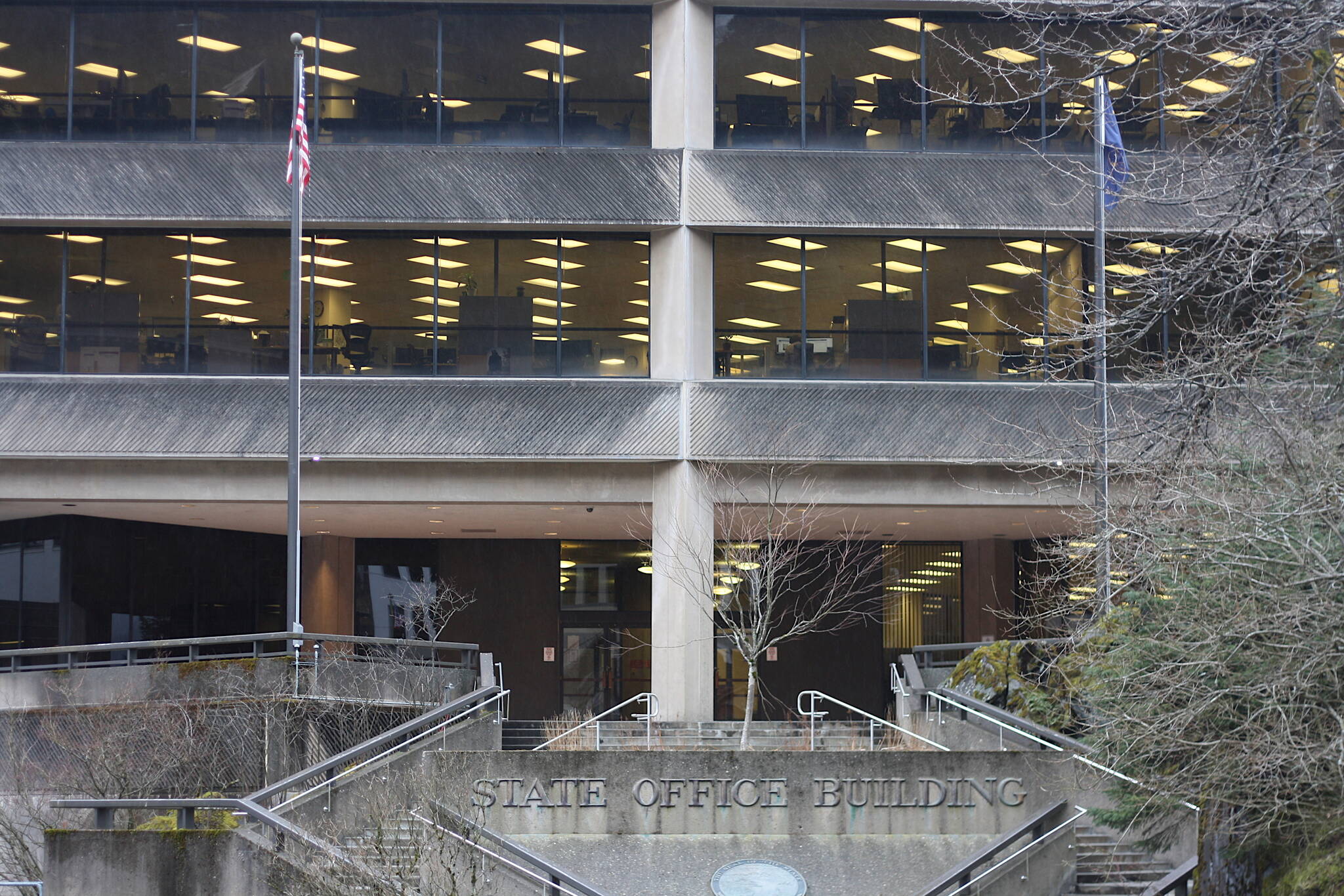 Flags fly outside the State Office Building on Friday, where a note police described as a possible threat against children was discovered at midday on Friday. (Mark Sabbatini / Juneau Empire)