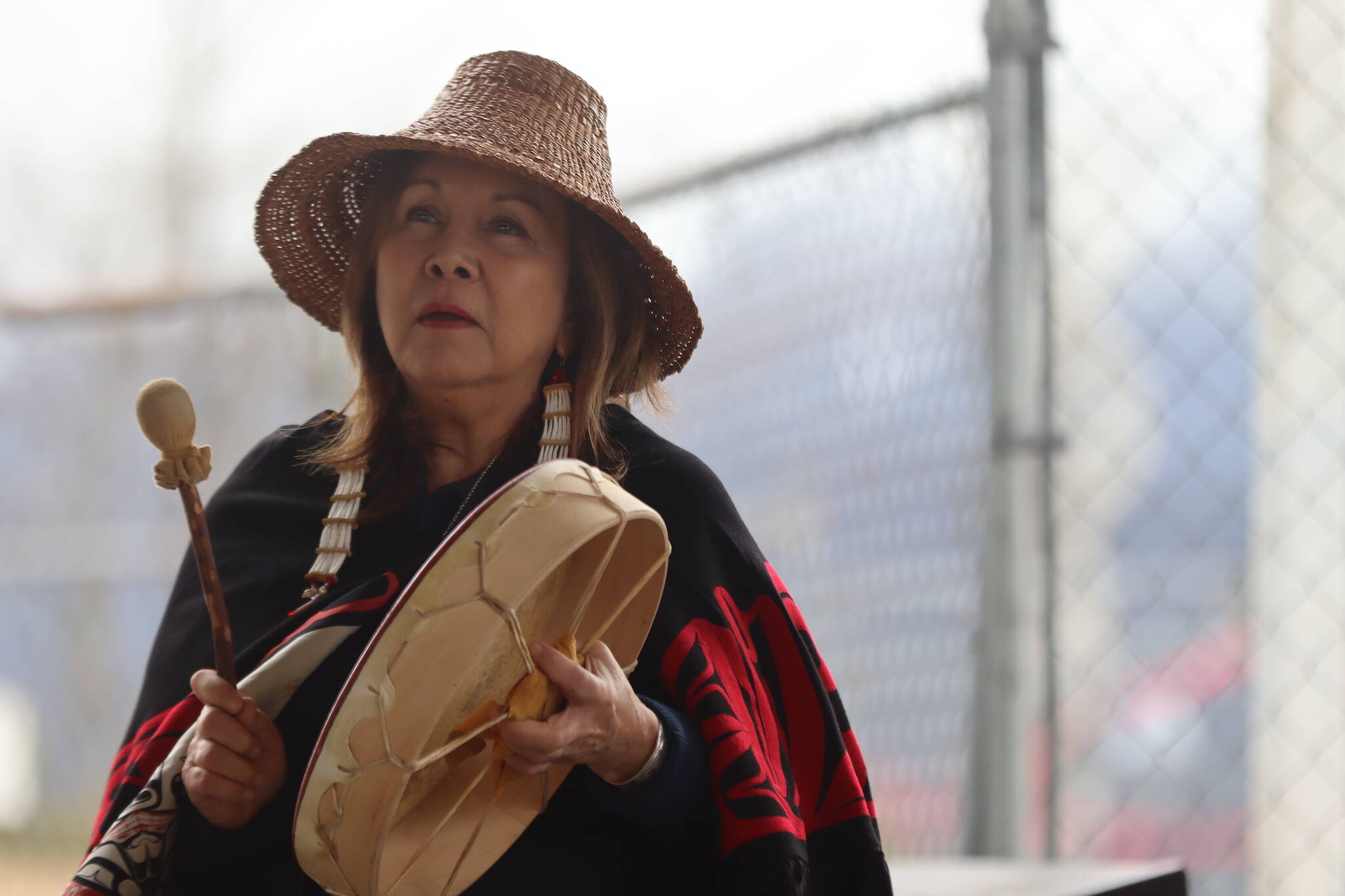 Nancy Barnes of the Chugach Villages leads people gathered at Marine Park on Friday through songs and prayers as part of the blessing ceremony for the Kootéeyaa Deiyí (Totem Pole Trail) that will run along the downtown Juneau waterfront. (Jonson Kuhn / Juneau Empire)