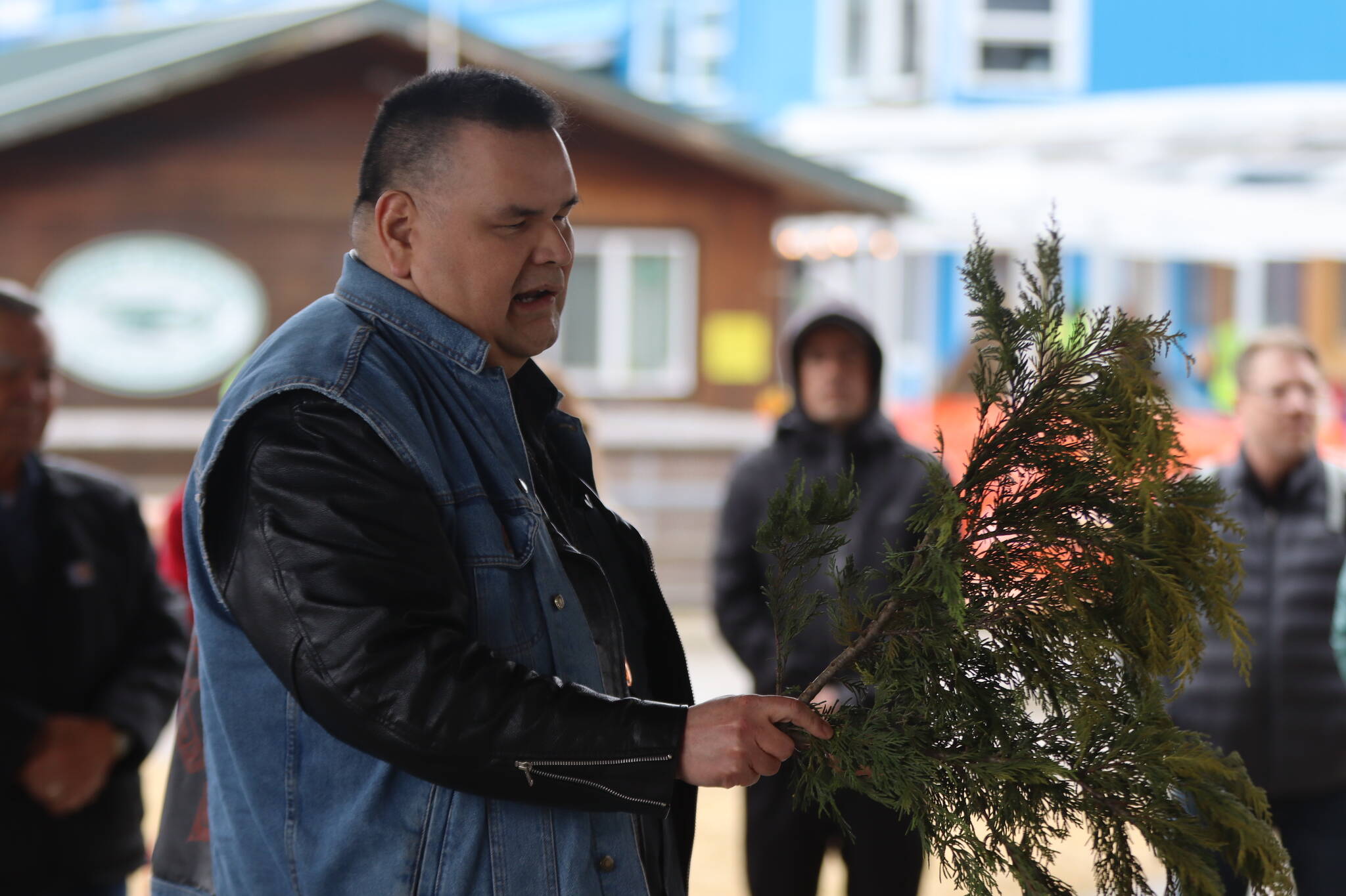 Alfie Price performs a traditional blessing of the ground on Friday at Marine Park where the Kootéeyaa Deiyí (Totem Pole Trail) will be installed by the end of April. (Jonson Kuhn / Juneau Empire)