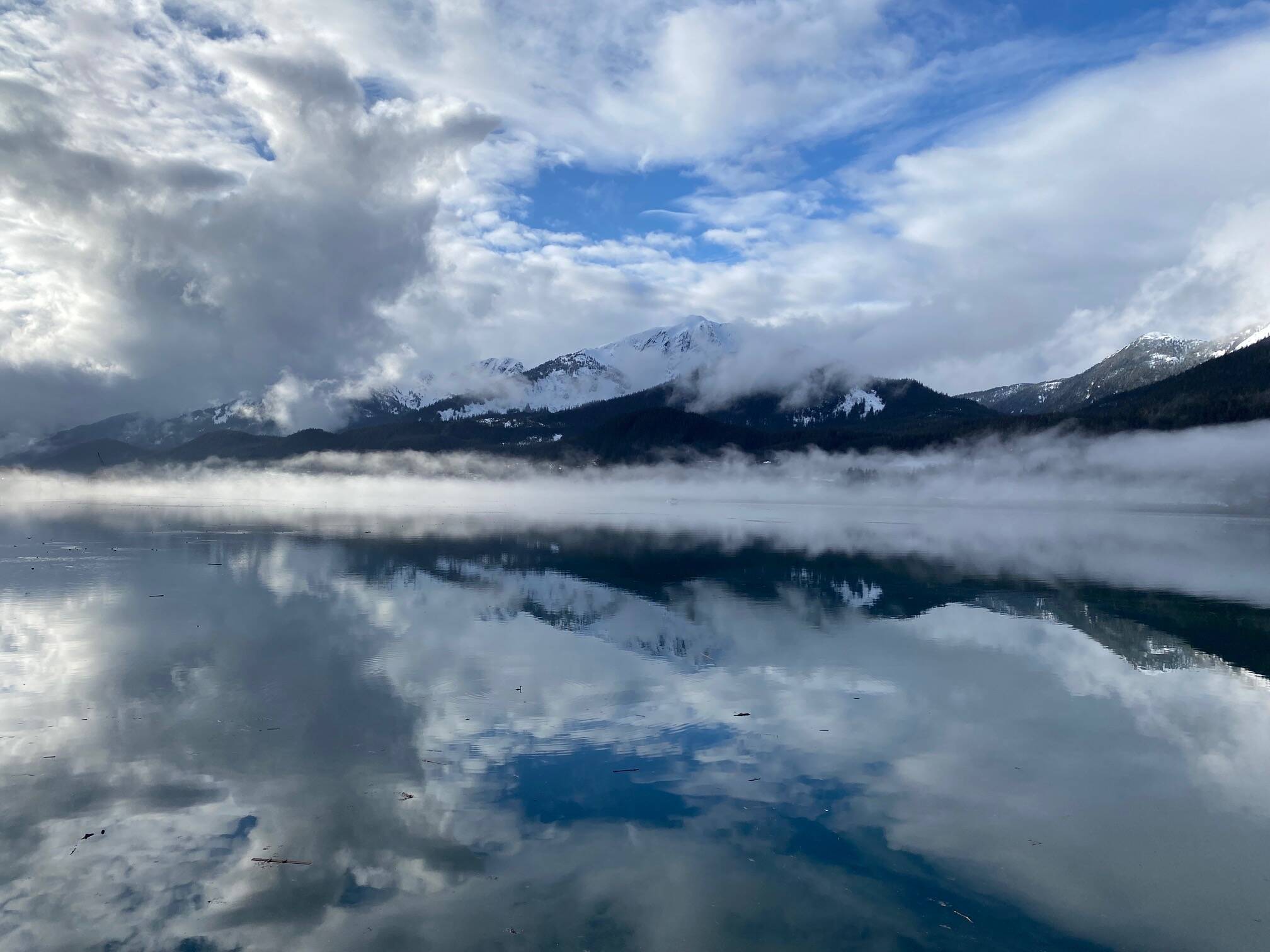 This photo shows the reflection of Mount Jumbo, clouds and blue sky in Gastineau Channel seen on March 24. (Courtesy Photo / Denise Carroll)