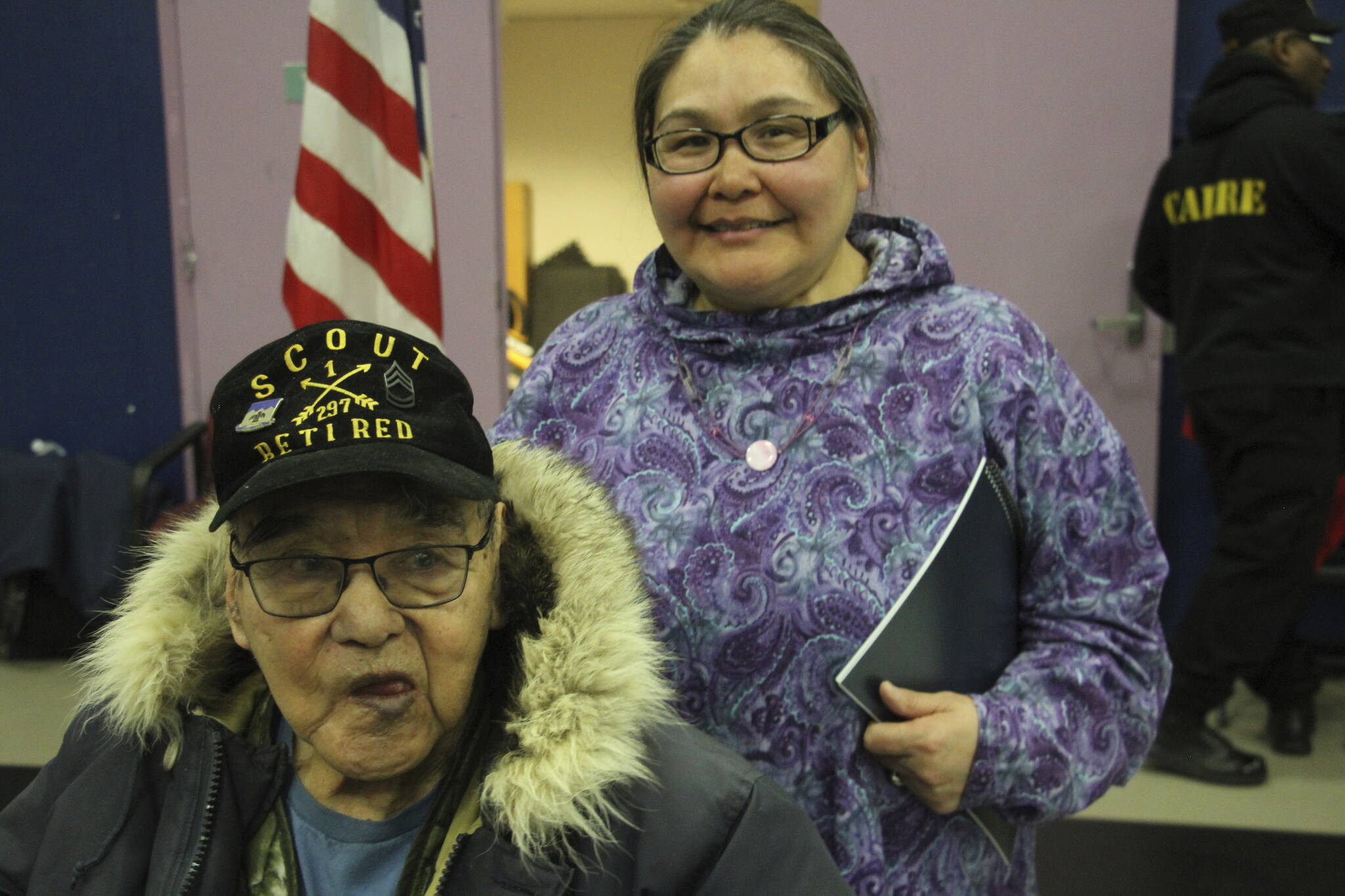 This March 28, 2023, photo shows Bruce Boolowon, left, posing with his eldest daughter, Rhona Pani Apassingok, at an Alaska National Guard ceremony in Gambell, Alaska. Maj. Gen. Torrence Saxe, the adjutant general of the Alaska National Guard, presented Alaska Heroism Medals to Boolowon, the last surviving guardsman of 16 who helped rescue 11 Navy crewmen after they crash landed on St. Lawrence Island on June 22, 1955, and to the family members of 15 other guardsman who are now deceased. (AP Photo / Mark Thiessen)