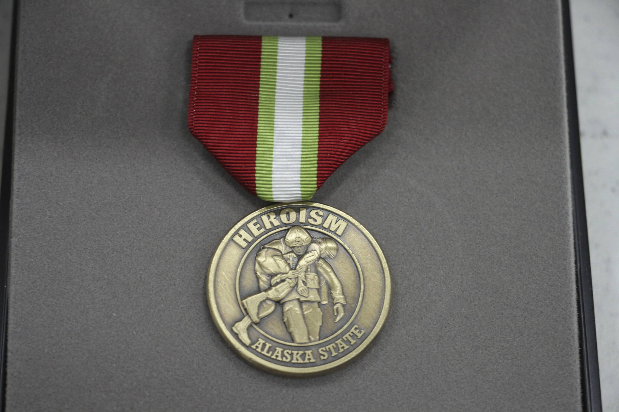 This March 28, 2023, photo shows an Alaska Heroism Medal prior to a ceremony in Gambell, Alaska, to honor 16 Alaska National Guard members. The guardsman rescued 11 Navy crewman who were injured when they crash landed on St. Lawrence Island after being shot down by Soviet MiG-15 jet fighters on June 22, 1955. (AP Photo / Mark Thiessen)
