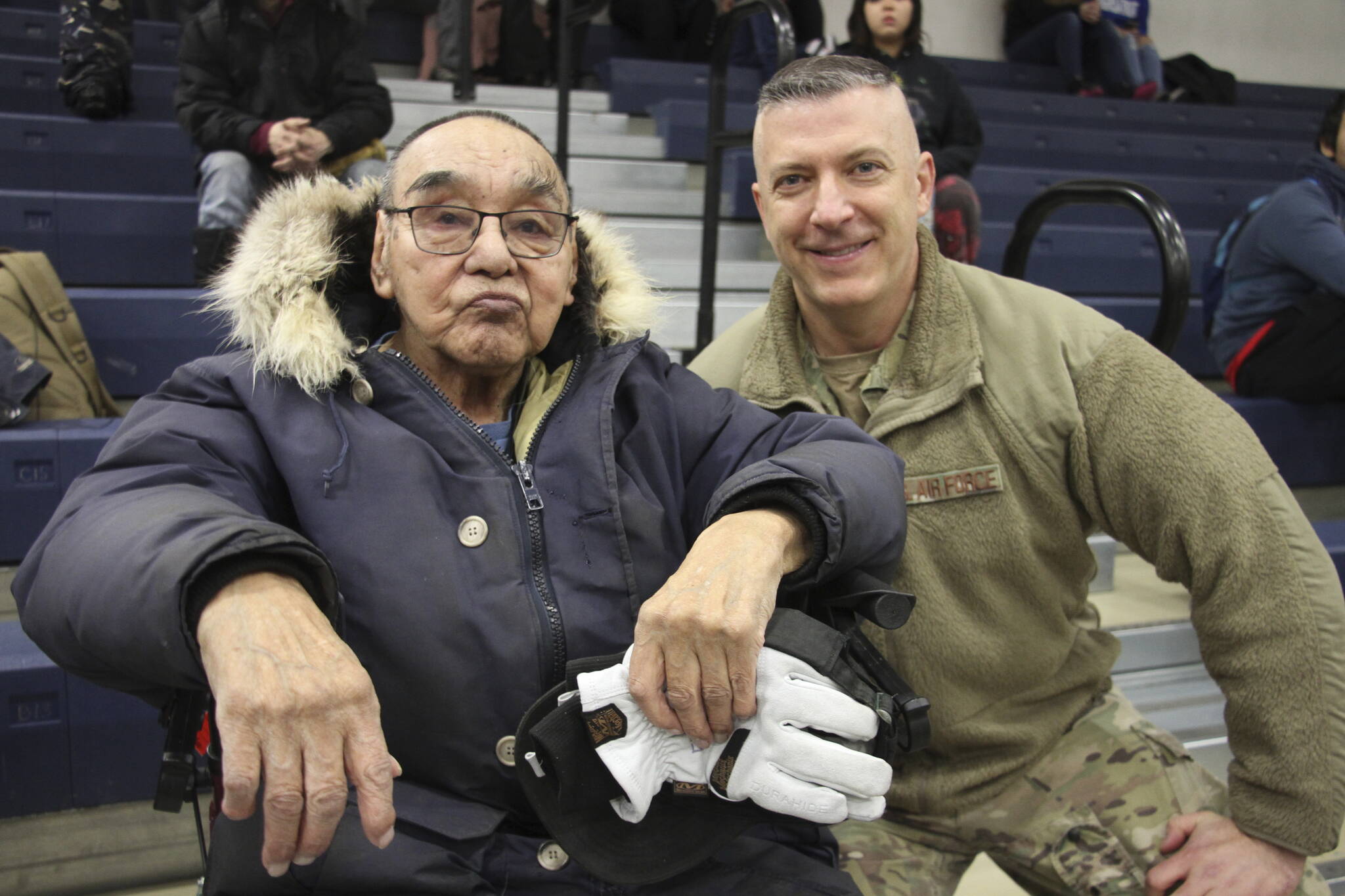 This March 28, 2023, photo shows Bruce Boolowon, left, posing with Maj. Gen. Torrence Saxe, the adjutant general of the Alaska National Guard, during a ceremony in Gambell, Alaska. Saxe presented Alaska Heroism Medals to Boolowon, the last surviving guardsman who helped rescue 11 Navy crewmen after they crash landed on St. Lawrence Island on June 22, 1955, and to the family members of 15 other guardsman who are now deceased. (AP Photo/Mark Thiessen)