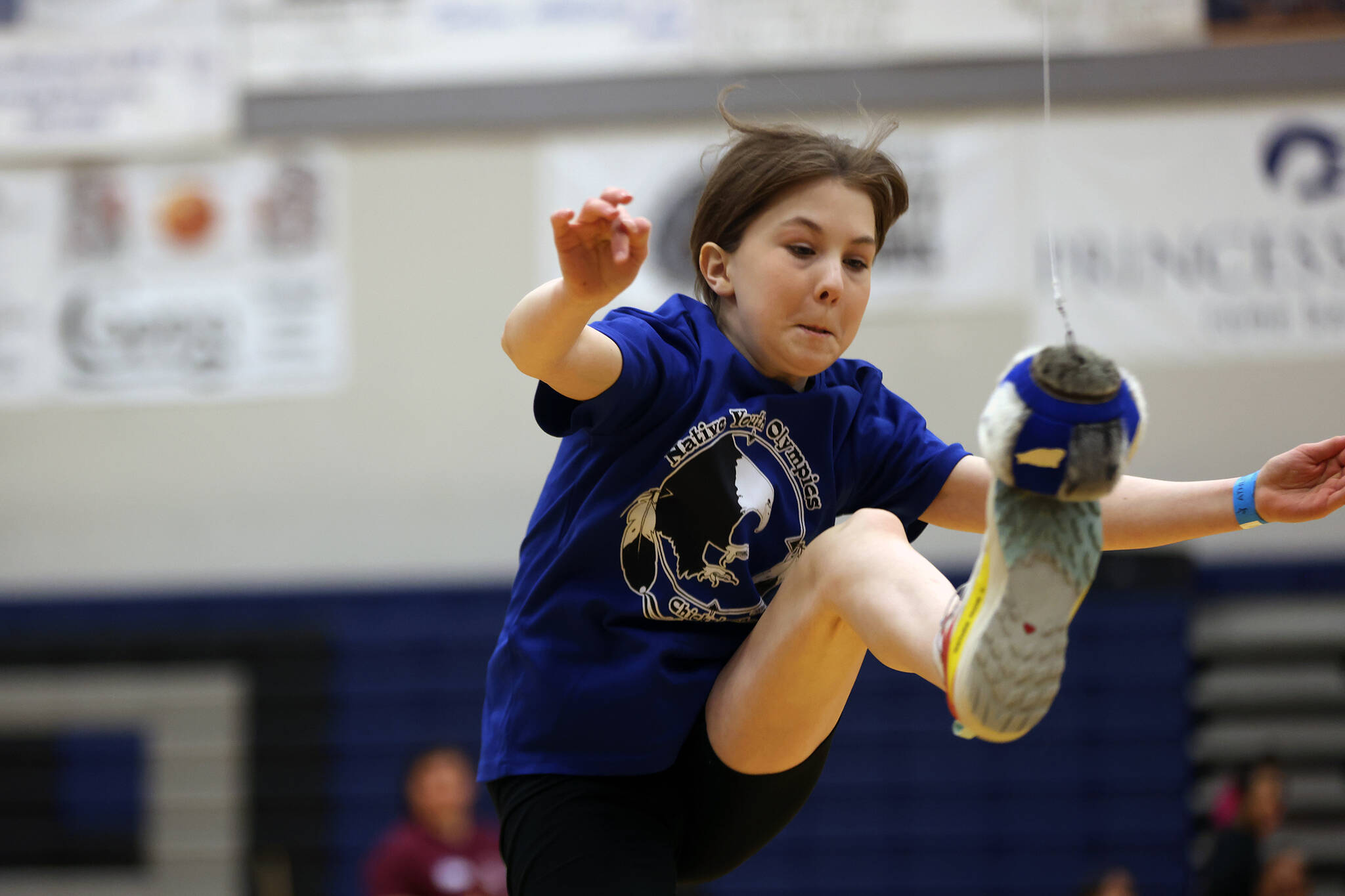 Maya Boger, 11, of Chickaloon connects with the ball during the one-foot high kick. The event was one of many during this year’s Traditional Games. (Ben Hohenstatt / Juneau Empire)