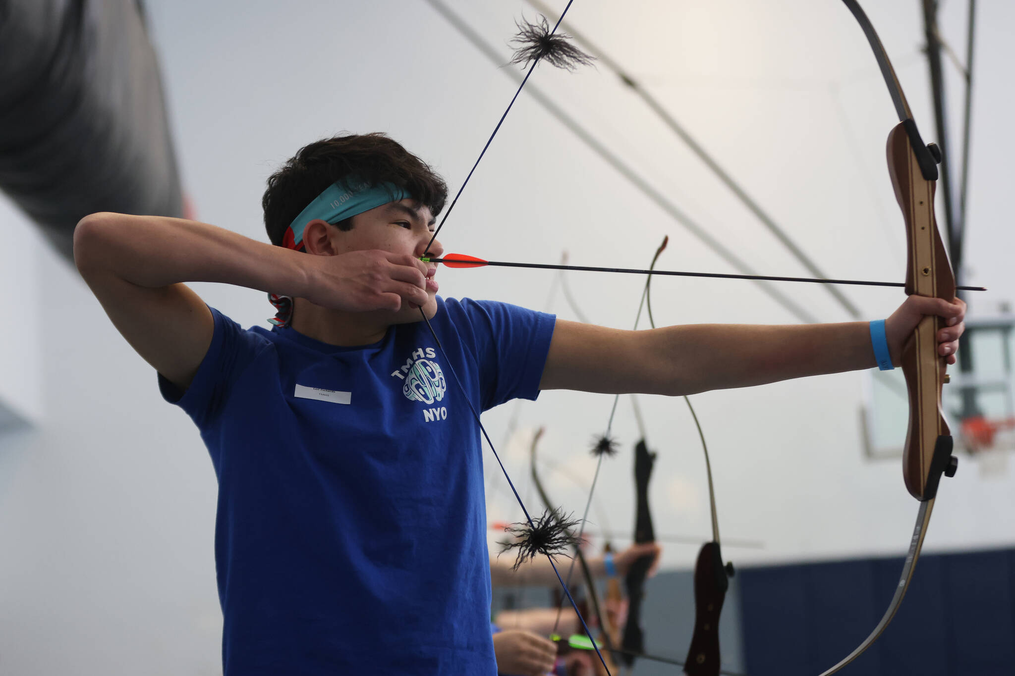 Lee Richards, a Thunder Mountain High School sophomore, gets ready to let an arrow fly during this year’s Traditional Games held Saturday and Sunday at the high school in Juneau. This year’s games were the first to feature archery. (Ben Hohenstatt / Juneau Empire)