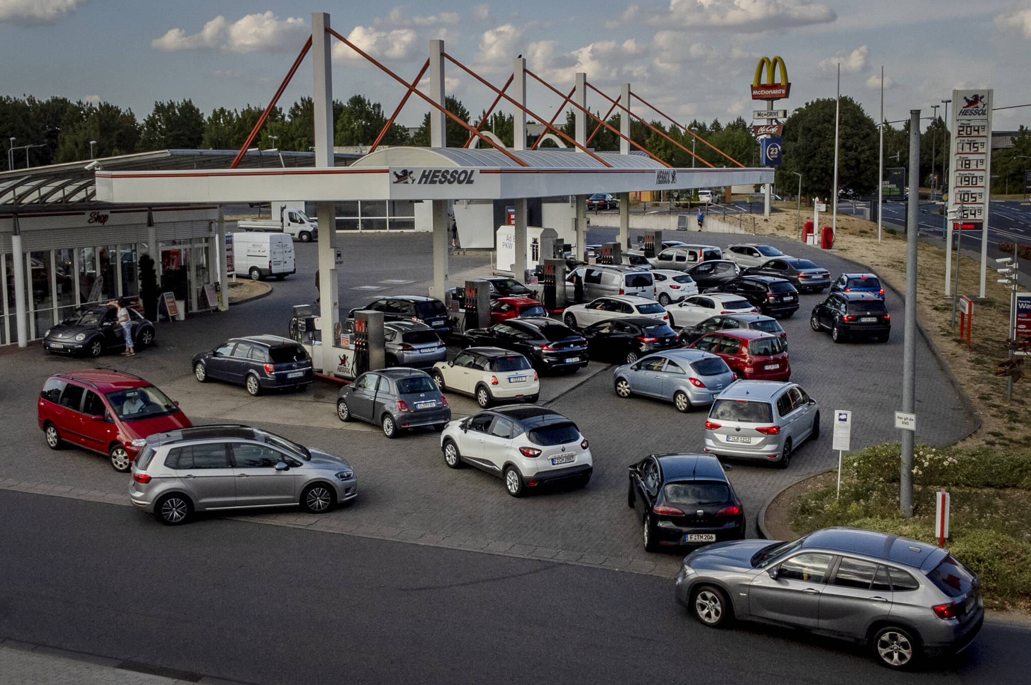 People queue with their cars at a gas station in Frankfurt, Germany, on Aug. 31, 2022, the last day when the government's fuel prize discount is in effect. Major oil-producing countries led by Saudi Arabia and Russia have said they're throttling back supplies of crude — again. And this time, the decision to cut back was a surprise that is underlining worries about where the global economy might be headed. (AP Photo / Michael Probst)