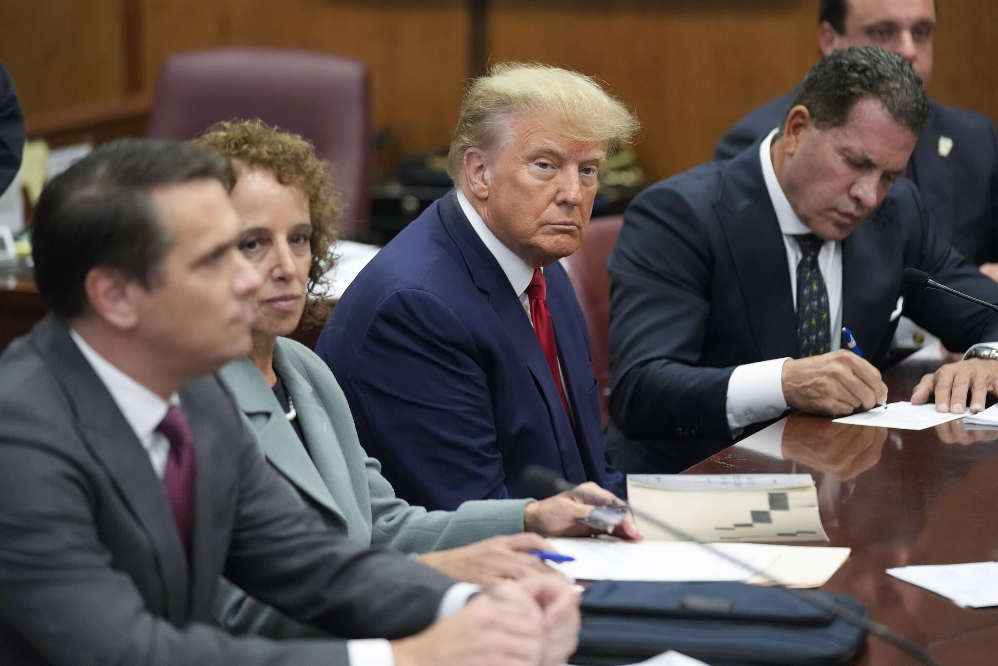 Former President Donald Trump sits at the defense table with his legal team in a Manhattan court, Tuesday, April 4, 2023, in New York. Trump is appearing in court on charges related to falsifying business records in a hush money investigation, the first president ever to be charged with a crime. (AP Photo / Seth Wenig)