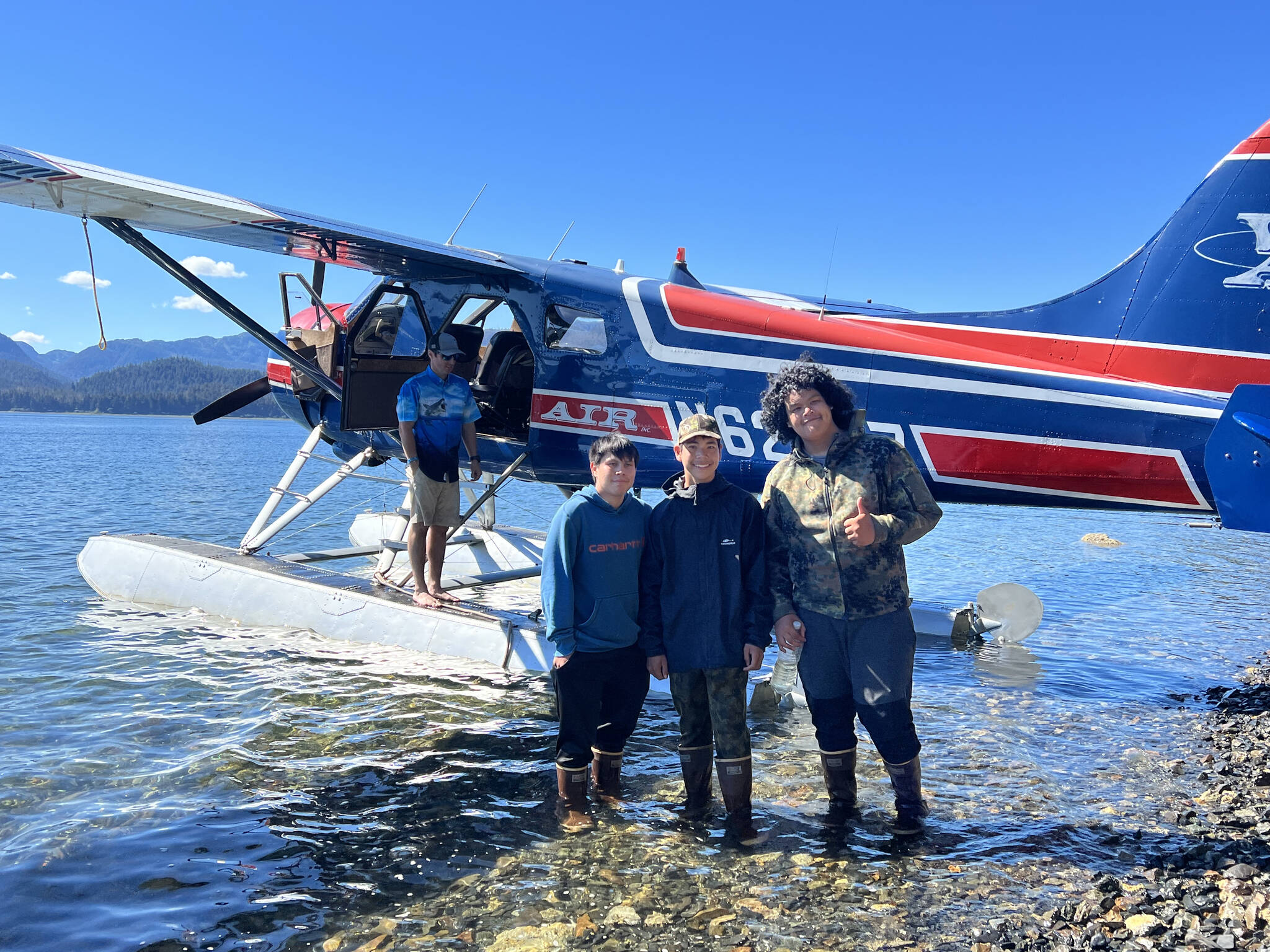 From left to right, Sam Fredrickson, Trevor Fredrickson and Beebuks Kookesh as they board the Ward Air floatplane that would return them home, to Angoon, after paddling and hiking the cross-Admiralty canoe route. (Courtesy Photo / Mary Catharine Martin)