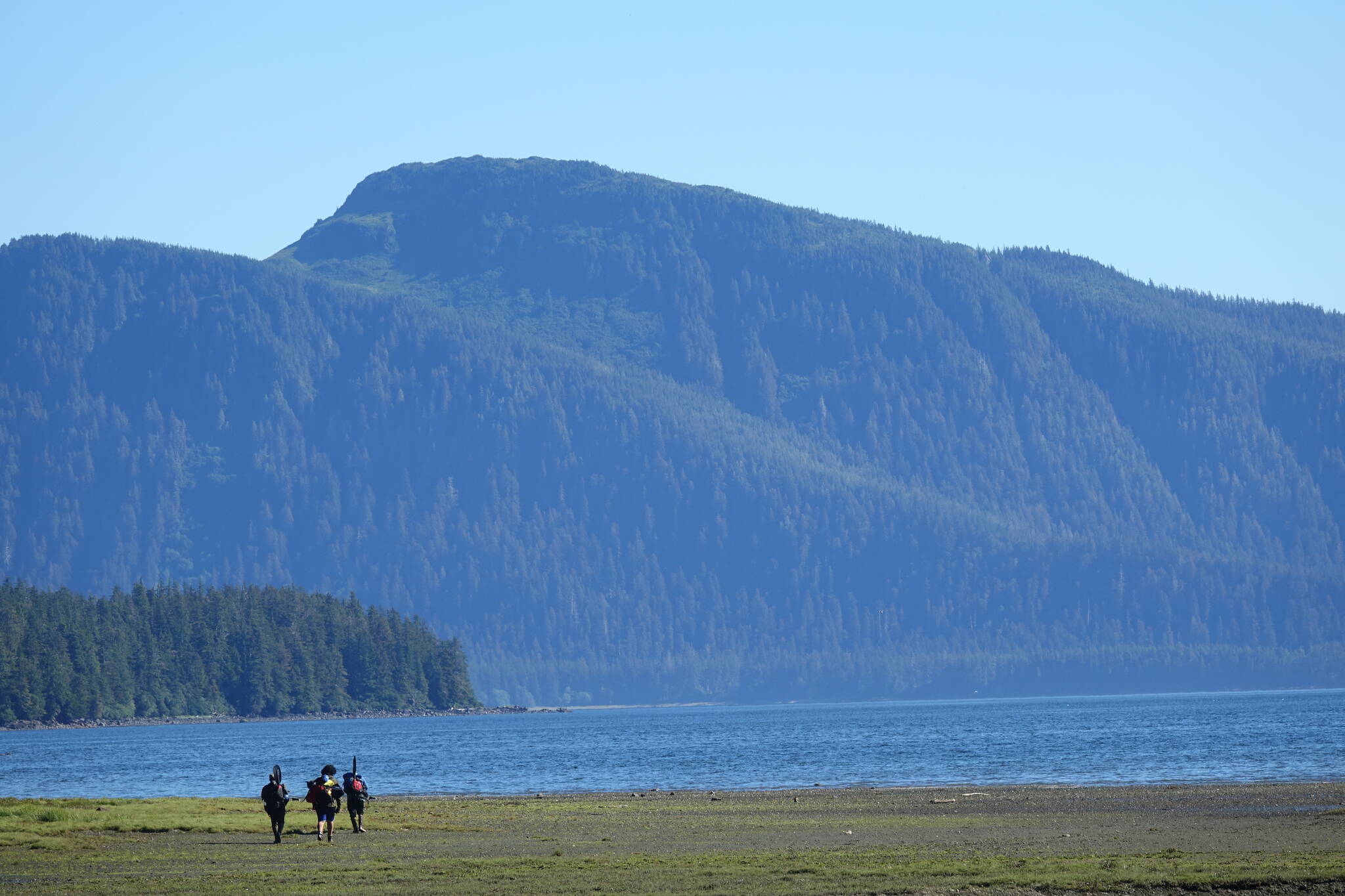 Trevor Fredrickson, Sam Fredrickson and Beebuks Kookesh hike down to the shore on the way to be picked up by a floatplane that would return them home, to Angoon. (Courtesy Photo / Mary Catharine Martin)