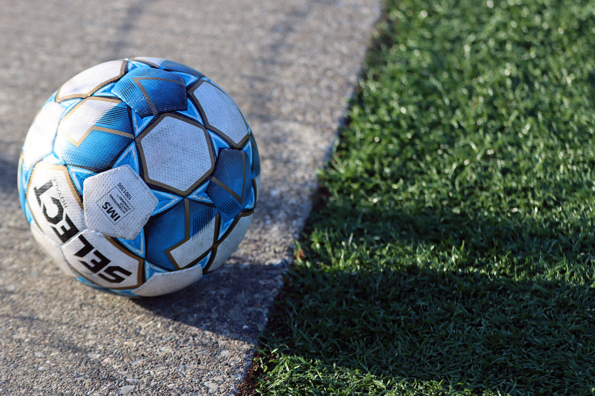 A soccer ball rests on the field at Thunder Mountain High School. The JDHS girls bested TMHS 9-0 on Wednesday behind five goals from Peyton Wheeler. The young JDHS team will play again soon, with Friday and Saturday games against Ketchikan High School. (Ben Hohenstatt / Juneau Empire)
