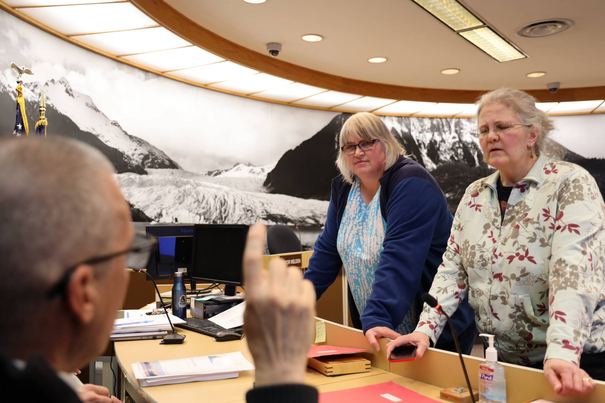 City and Borough of Juneau Mayor Beth Weldon and Assembly Member Michelle Bonnet Hale talk with City Manager Rorie Watt Wednesday night after the the 2024-2025 municipal budget was introduced at the city finance committee meeting. (Clarise Larson / Juneau Empire)