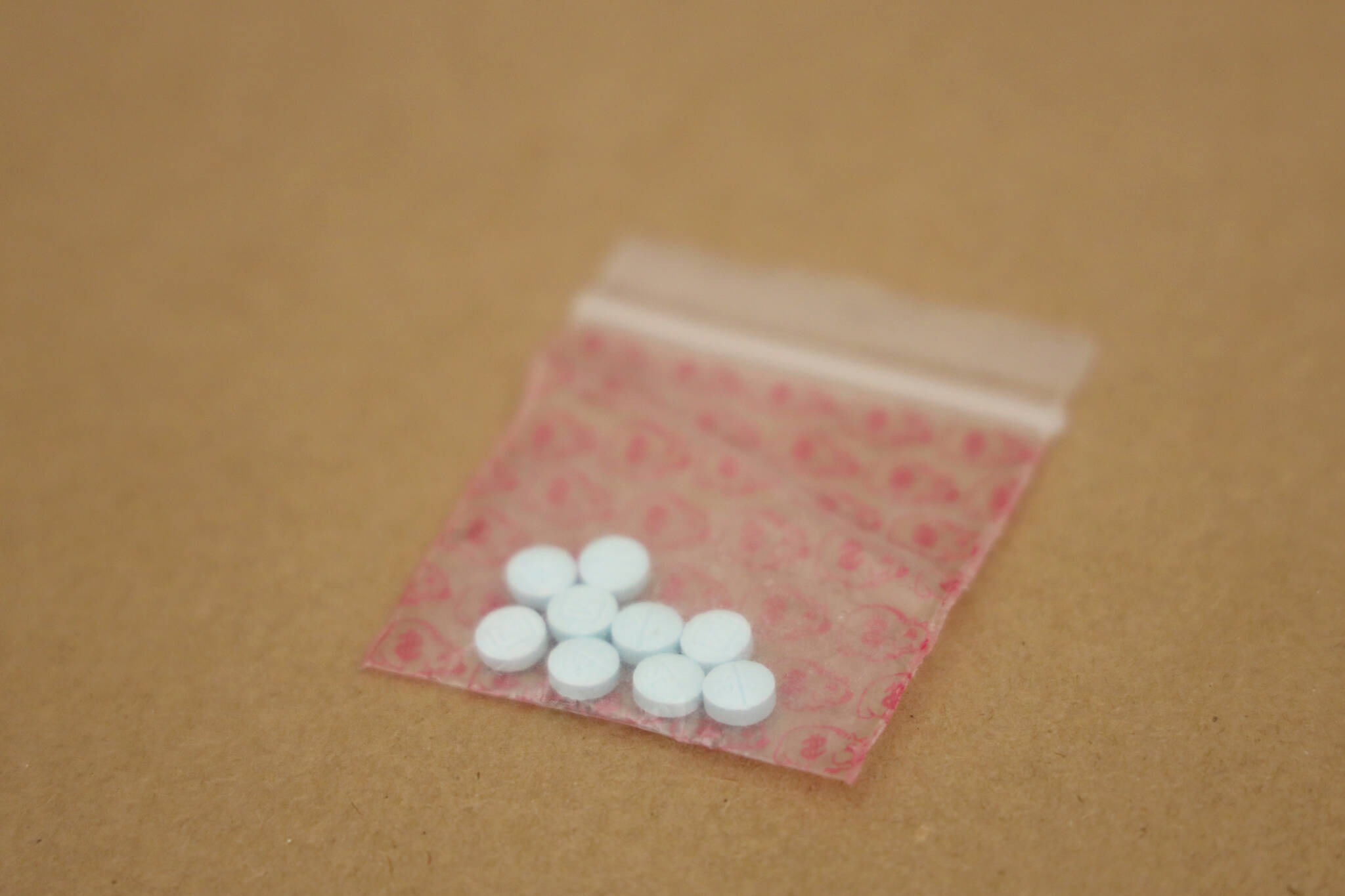 This March 10 photo shows fentanyl pills seized by police. A Juneau woman was arrested Saturday on a felony drug charge and police seized over 6,000 pills suspected to contain fentanyl. (Clarise Larson / Juneau Empire File)