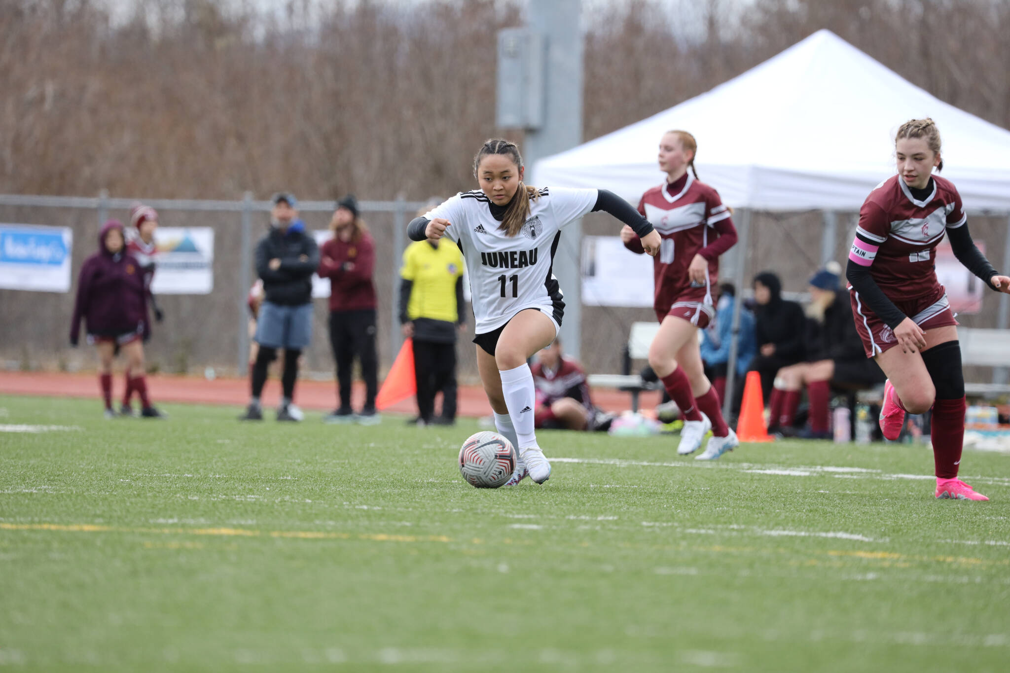 JDHS sophomore midfielder/forward Milina Mazon sprints past two Ketchikan players during a Saturday afternoon game against the team at Thunder Mountain High School. (Clarise Larson / Juneau Empire)