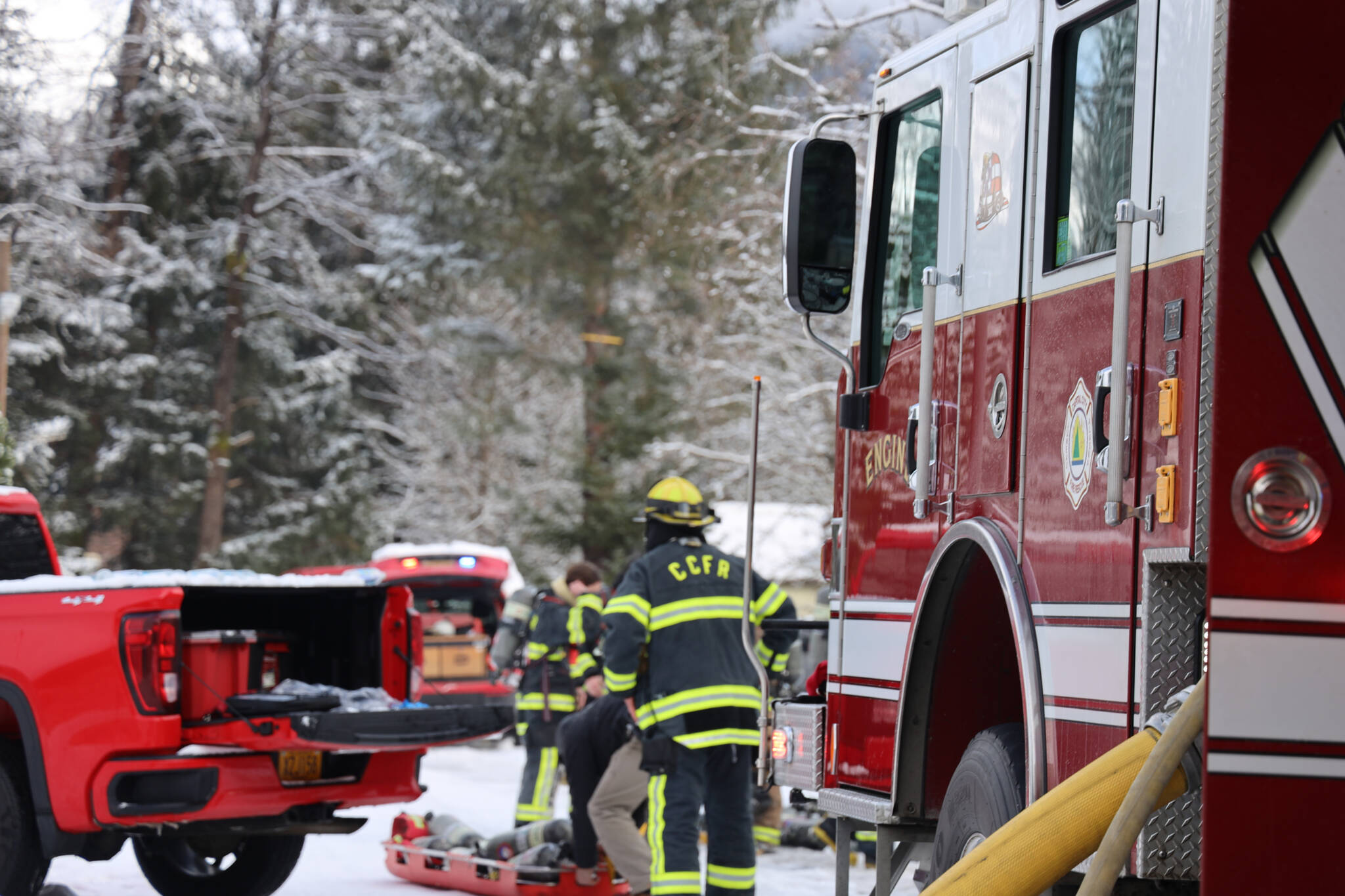 Capital City Fire/Rescue firefighters move to extinguish a trailer fire in early March. CCFR officials talk about the importance of staying fire safe as spring approaches. (Clarise Larson / Juneau Empire File)