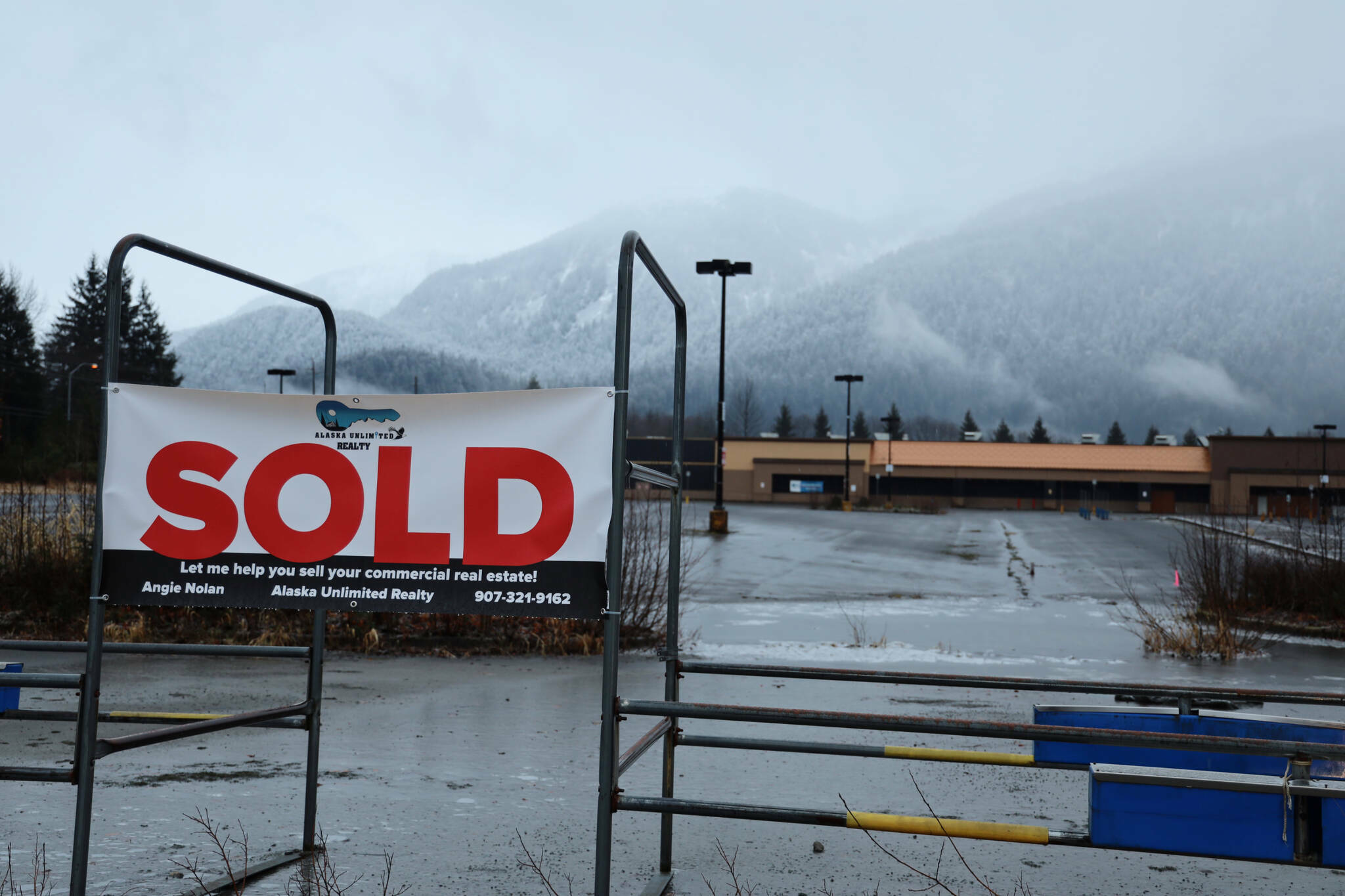 Clarise Larson / Juneau Empire File
A “sold” sign hangs outside the former Walmart building that was empty for many years until U-Haul purchased it late last year. A bill passed by the Senate on Tuesday would allow municipalities to impose tax penalties on blighted properties, while offering breaks for owners doing development projects.