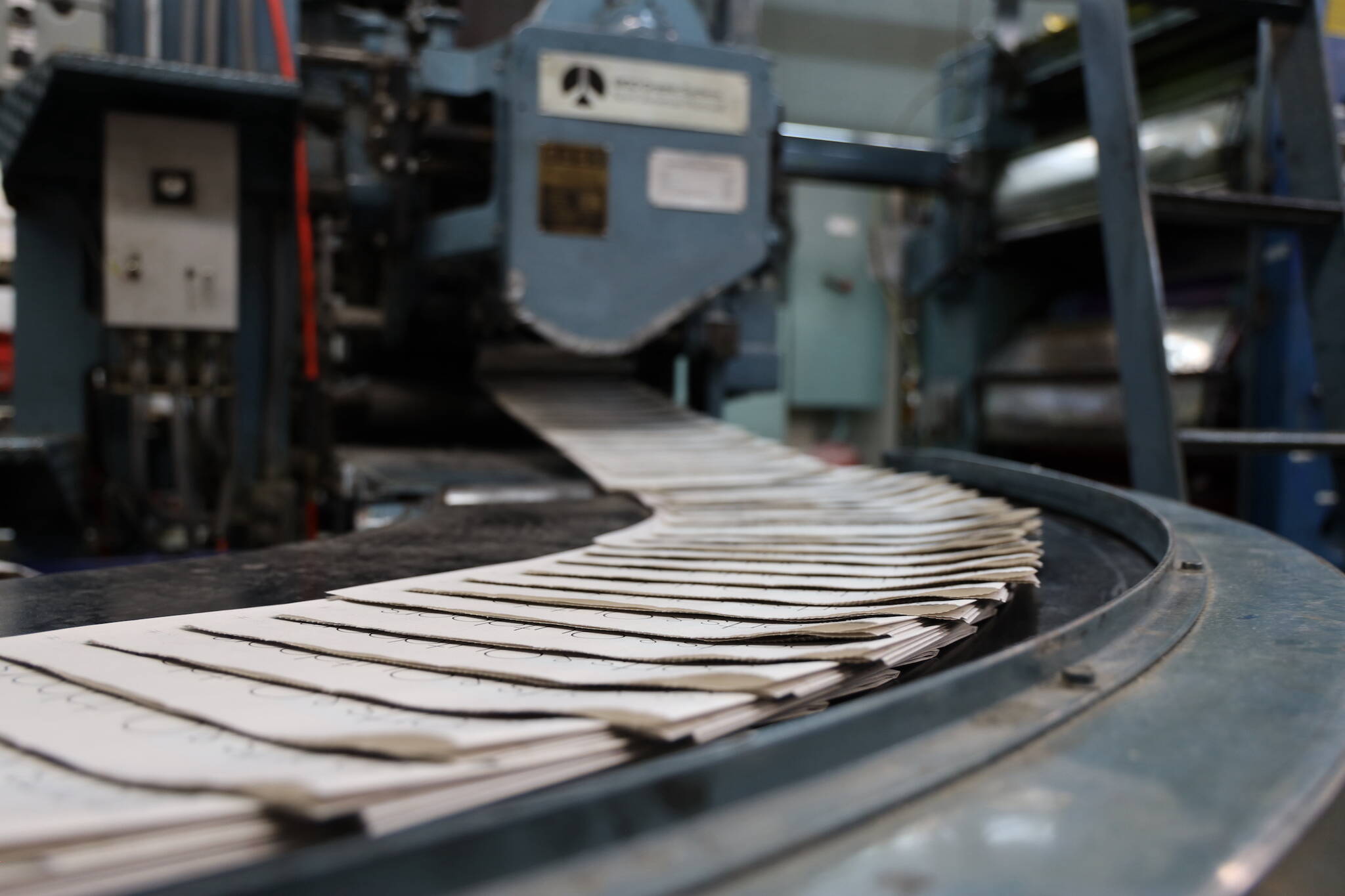 Freshly printed paper makes it way through the Juneau Empire printing press in Juneau Thursday evening. Beginning May 3, the Juneau Empire will be printed in Washington state, and delivered on Wednesdays and Saturdays. (Clarise Larson / Juneau Empire)