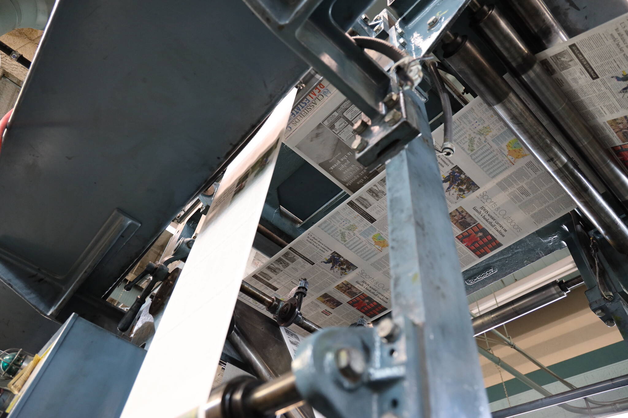 Freshly printed paper makes it way through the Juneau Empire printing press Thursday evening. Beginning May 3, the Juneau Empire will be printed in Washington state, and delivered on Wednesdays and Saturdays. (Clarise Larson / Juneau Empire)