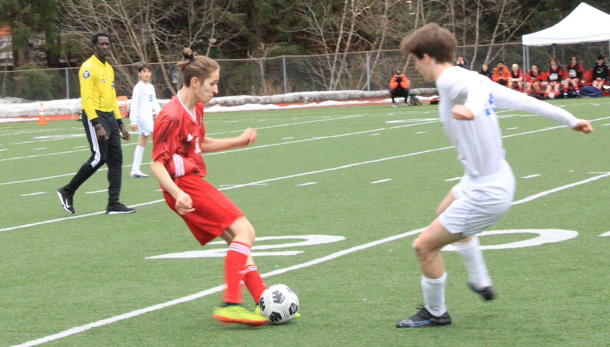 Xavier Melancon, a JDHS junior, maneuvers past a Thunder Mountain High School player on the pitch at the Adair-Kennedy field Monday evening. (Courtesy Photo / Dana Zigmund)