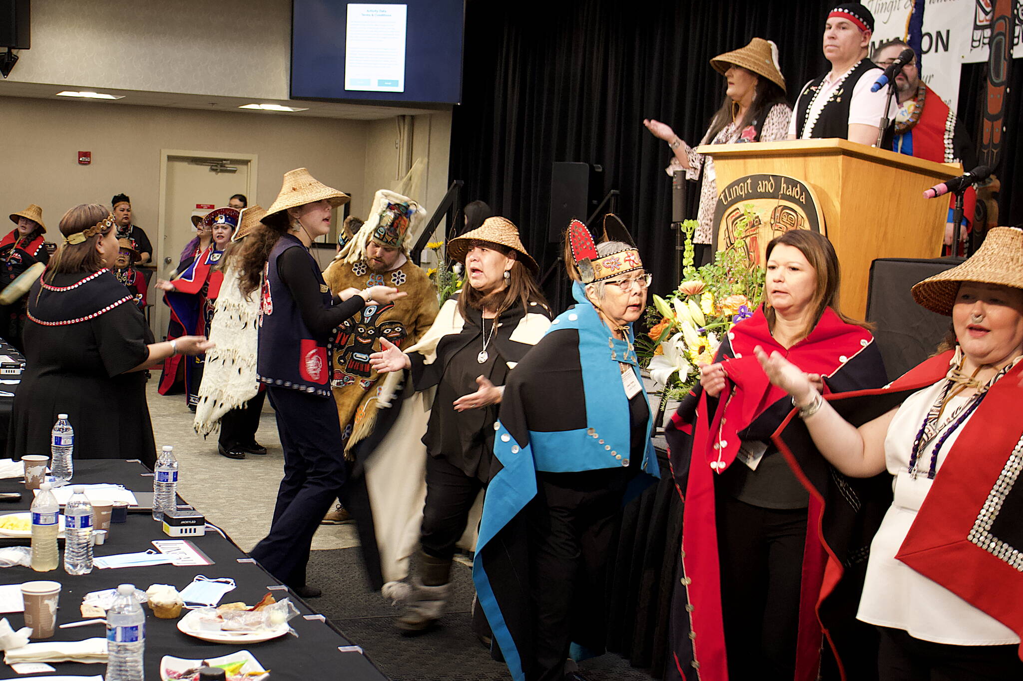 The Eagle/Raven Dance Group gathers at the stage in the main room of Elizabeth Peratrovich Hall on Wednesday morning to mark the grand entrance of delegates to the 88th annual tribal assembly of the Central Council of the Tlingit and Haida Indian Tribes of Alaska. (Mark Sabbatini / Juneau Empire)