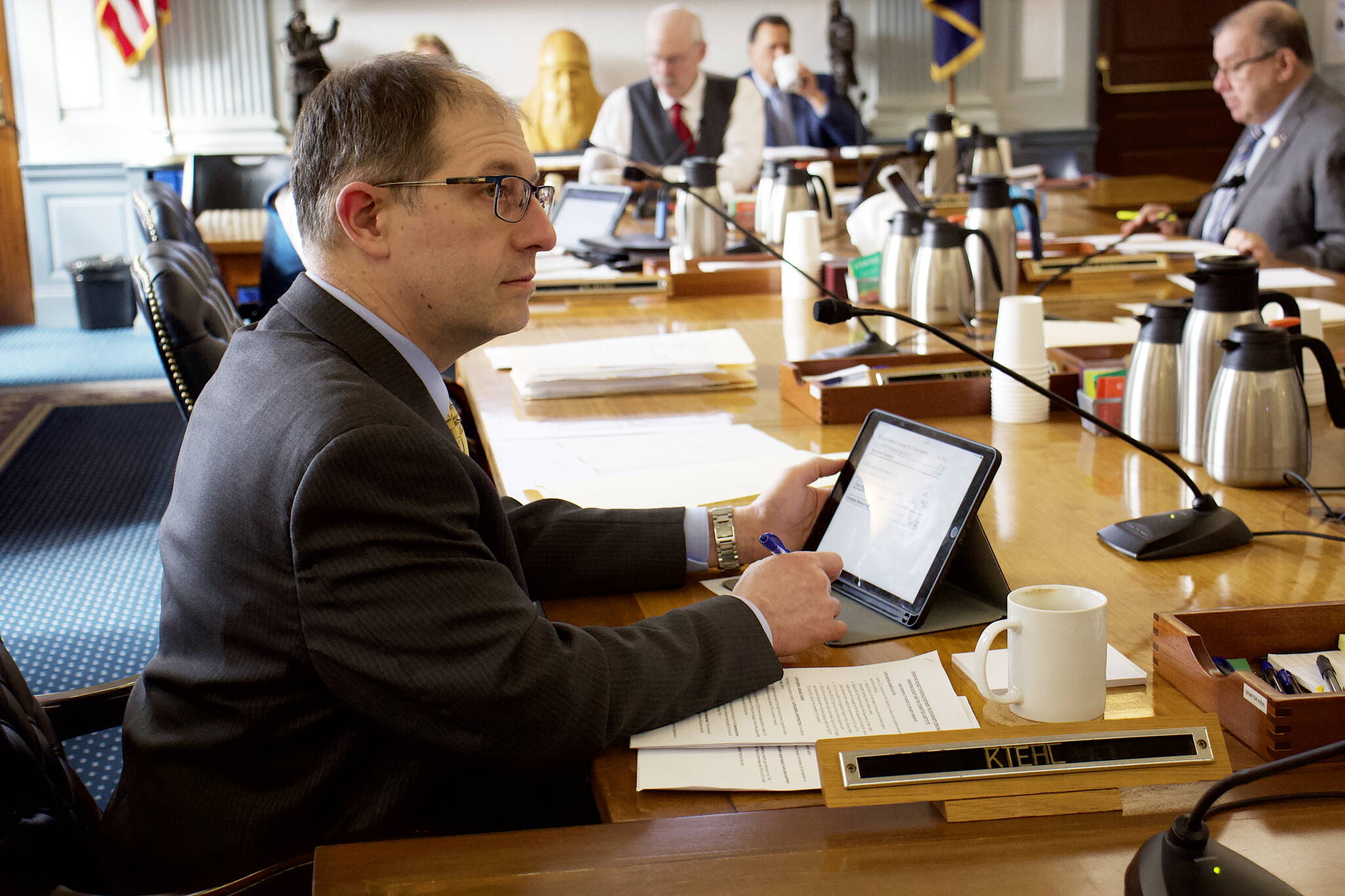 State Sen. Jesse Kiehl, D-Juneau, listens to an overview of the state’s balance sheet under a proposed budget for next year introduced by the Senate Finance Committee during a hearing Wednesday. The budget contains a surplus of more than $1.4 billion, but that’s a misleading number since it doesn’t include Permanent Fund Dividends, an increase in education funding and other spending that are virtually certain to be added following public testimony during the next couple of days. (Mark Sabbatini / Juneau Empire)