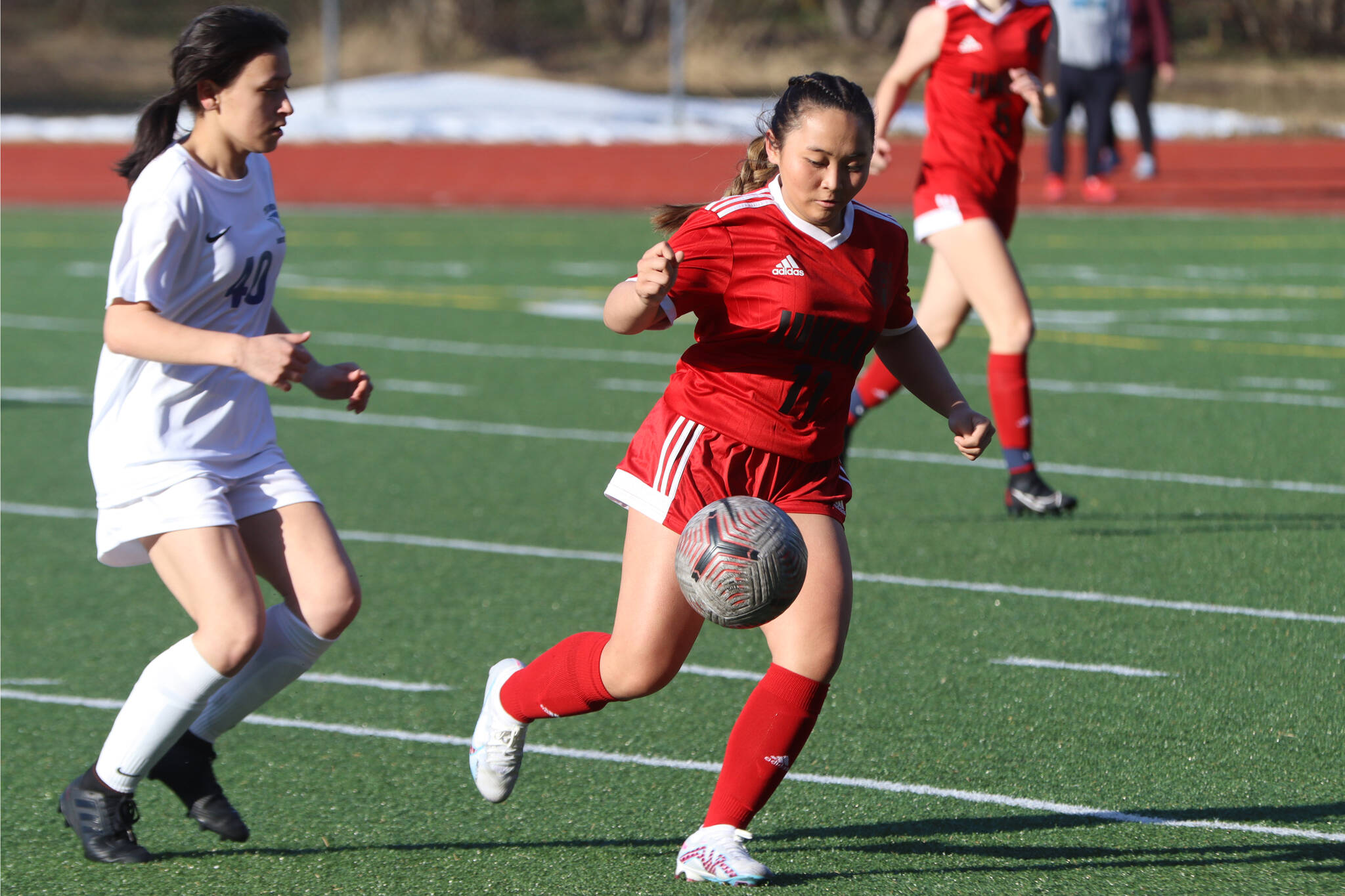 JDHS sophomore Milina Mazon (11) keeps the ball from TMHS freshman Ariana Gonzales (40) during the two schools second match up of the season on Tuesday at Adair-Kennedy Memorial Park. (Jonson Kuhn / Juneau Empire)