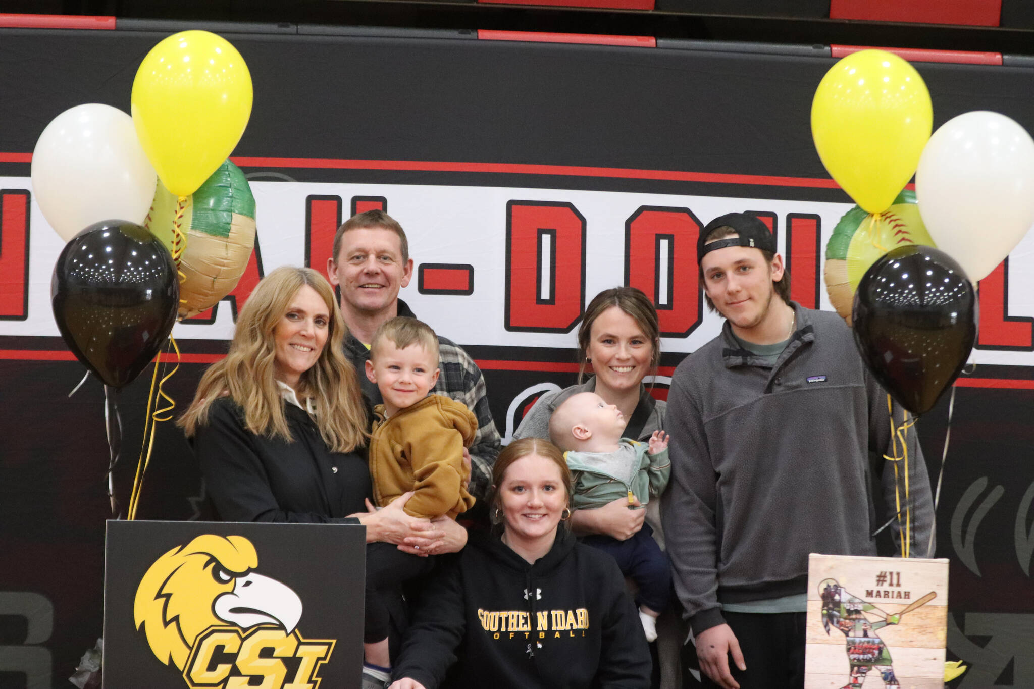 JDHS senior Mariah Schauwecker poses with her family for a photo on Wednesday after signing her letter of intent to play softball with Southern Idaho starting at the end of this summer. (Jonson Kuhn / Juneau Empire)