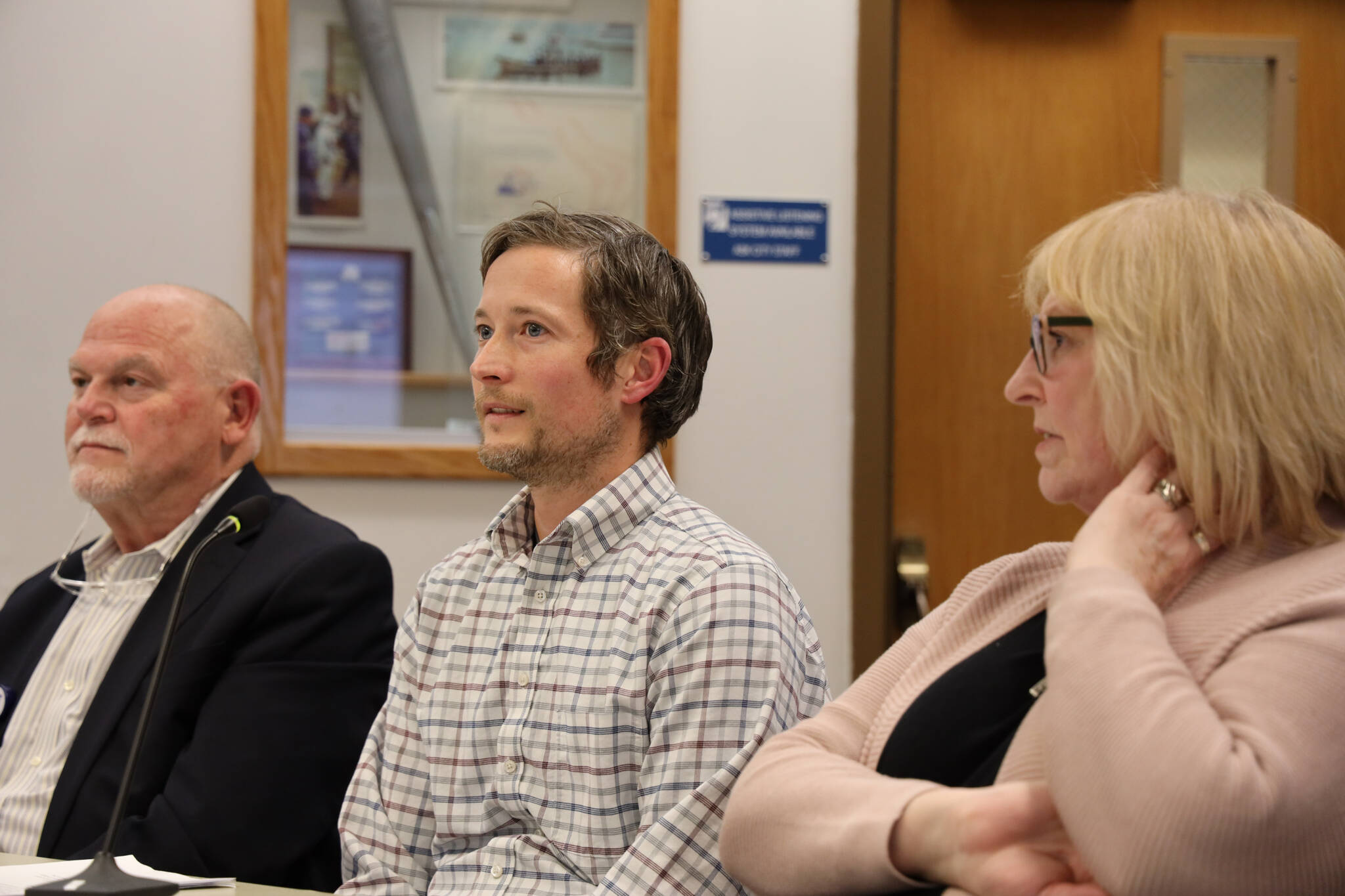 From left to right, Bartlett Regional Hospital CEO David Keith, chief financial officer Sam Muse and board Vice President Deborah Johnston sit before the Assembly to present the hospital’s 2024 fiscal year budget. The hospital is requesting an additional $5 million in funding from the city. (Clarise Larson / Juneau Empire)