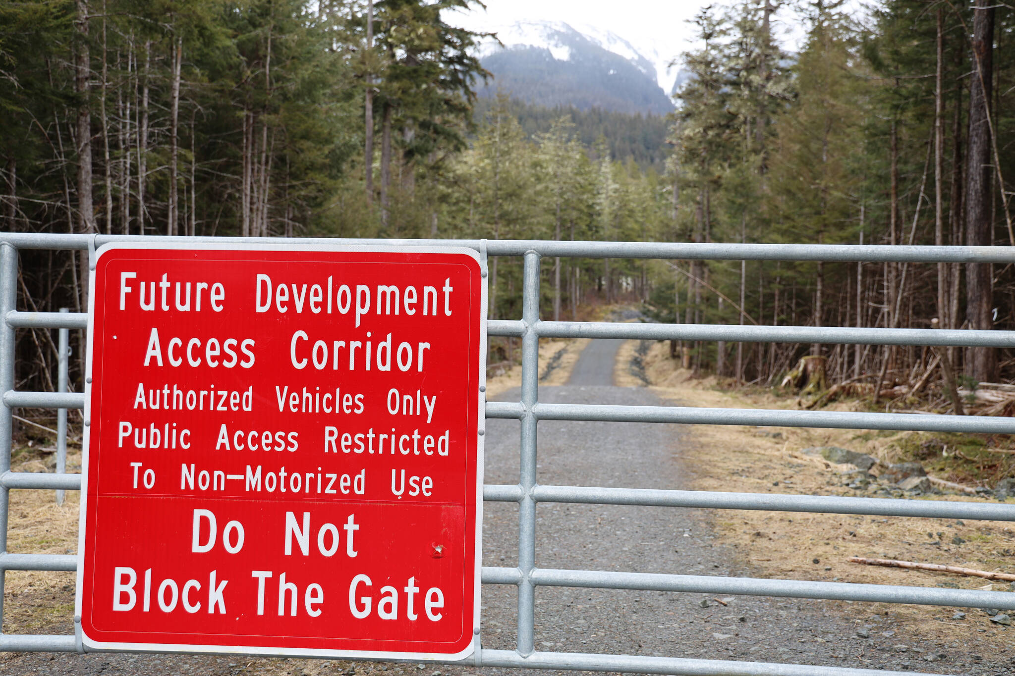 A gate blocks off the entrance to West Douglas’ Pioneer Road Saturday afternoon. Monday evening the City and Borough of Juneau Assembly voted to reject a proposal from a local company that sought to gain access to provide electric-assisted bicycle tours on the city-owned gravel road. (Clarise Larson / Juneau Empire)