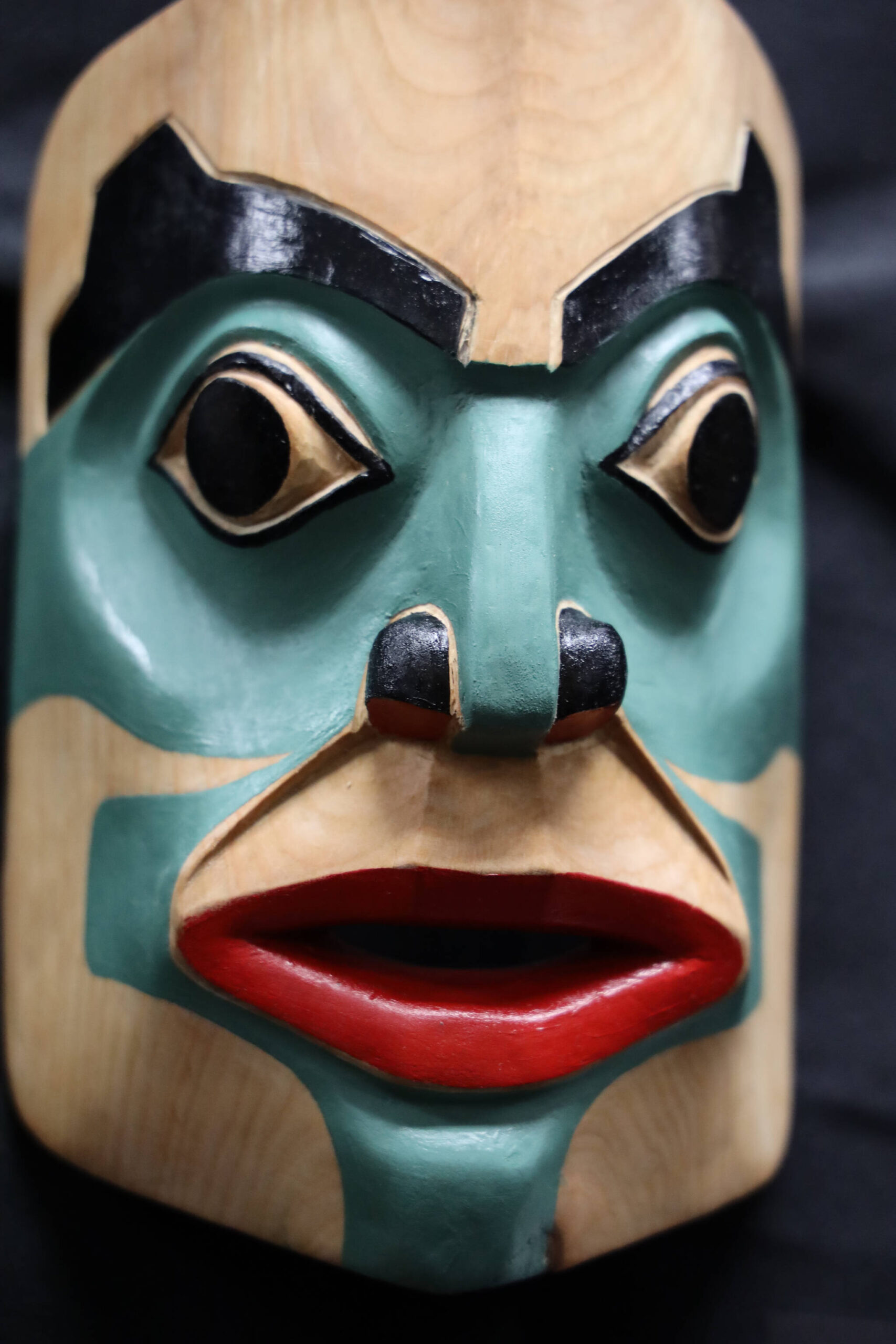 This mask titled “Hla dm baanu di baal’ack” was carved, without a planned sketch, by Tsimshian artist Huk Yuunsk David Lang. The piece was one of the many featured in a recent art gallery hosted Friday evening at the University of Alaska Southeast that showcased students’ work from the UAS Northwest Coast Art program. (Clarise Larson / Juneau Empire)