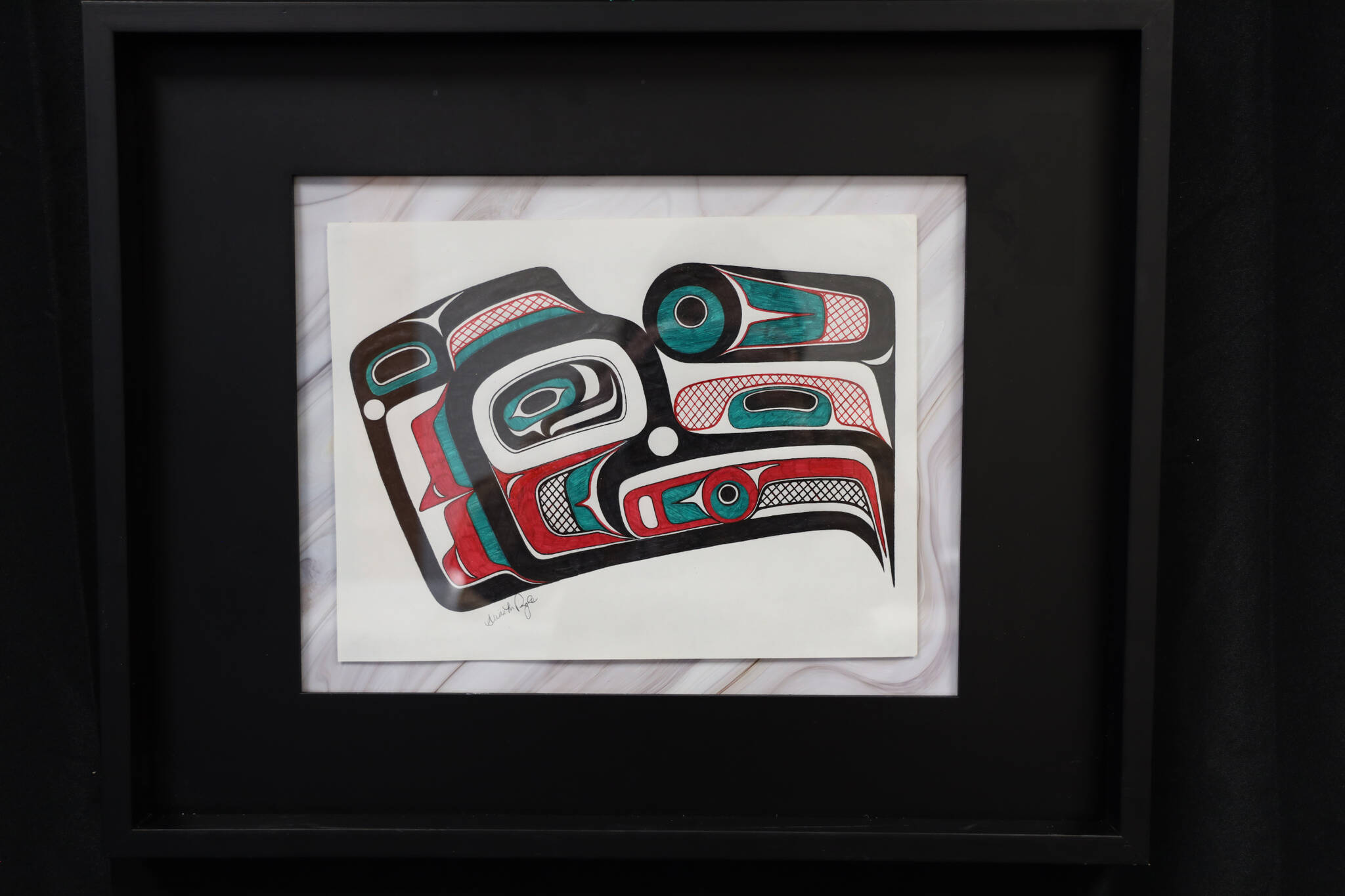 A Northwest Coast formline design by Juneau artist Alexis Pringle was one of the many featured in a recent art gallery hosted Friday evening at the University of Alaska Southeast that showcased students’ work from the UAS Northwest Coast Art program. (Clarise Larson / Juneau Empire)