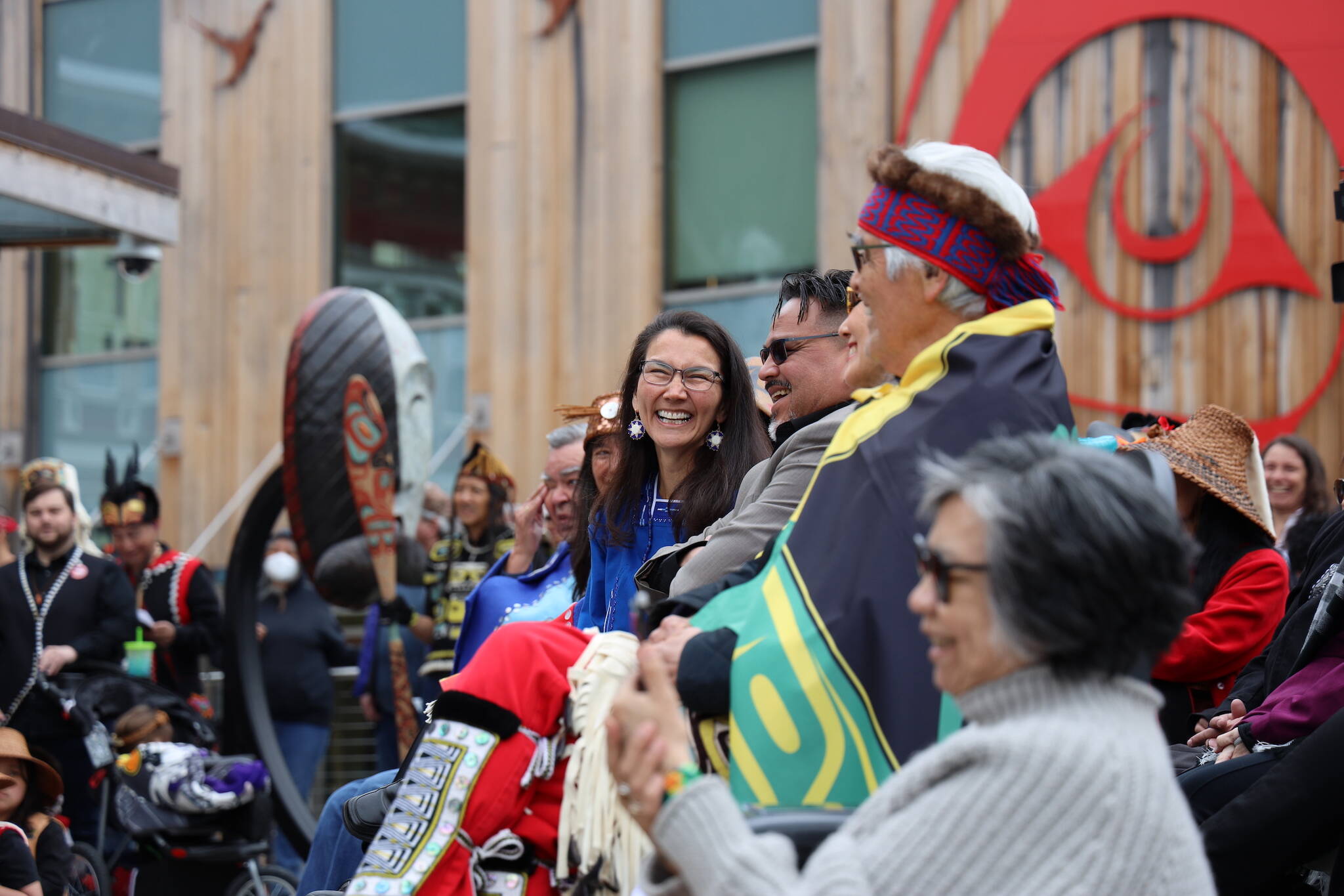 U.S. Rep. Mary Peltola, a Democrat and the first Alaska Native person to represent Alaska in Congress, laughs while sitting in the crowd at the dedication ceremony of the Kootéeyaa Deiyí, Totem Pole Trail, held Saturday in downtown Juneau at Heritage Plaza. (Clarise Larson / Juneau Empire)
