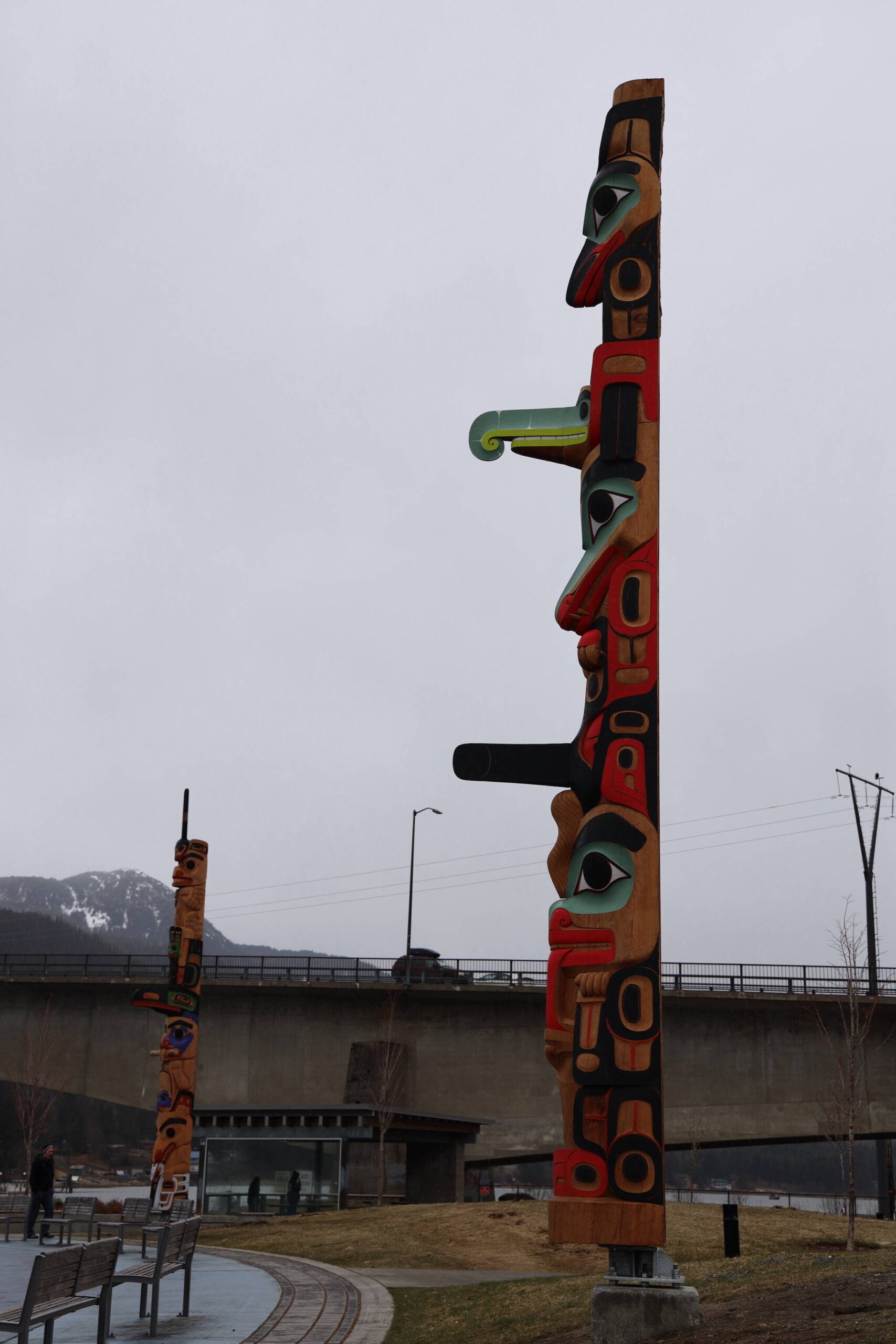 A totem pole by Tsimshian carver Gyibaawm Laxha David Robert Boxley stands tall during a light drizzle Saturday afternoon after the dedication ceremony. (Clarise Larson / Juneau Empire)