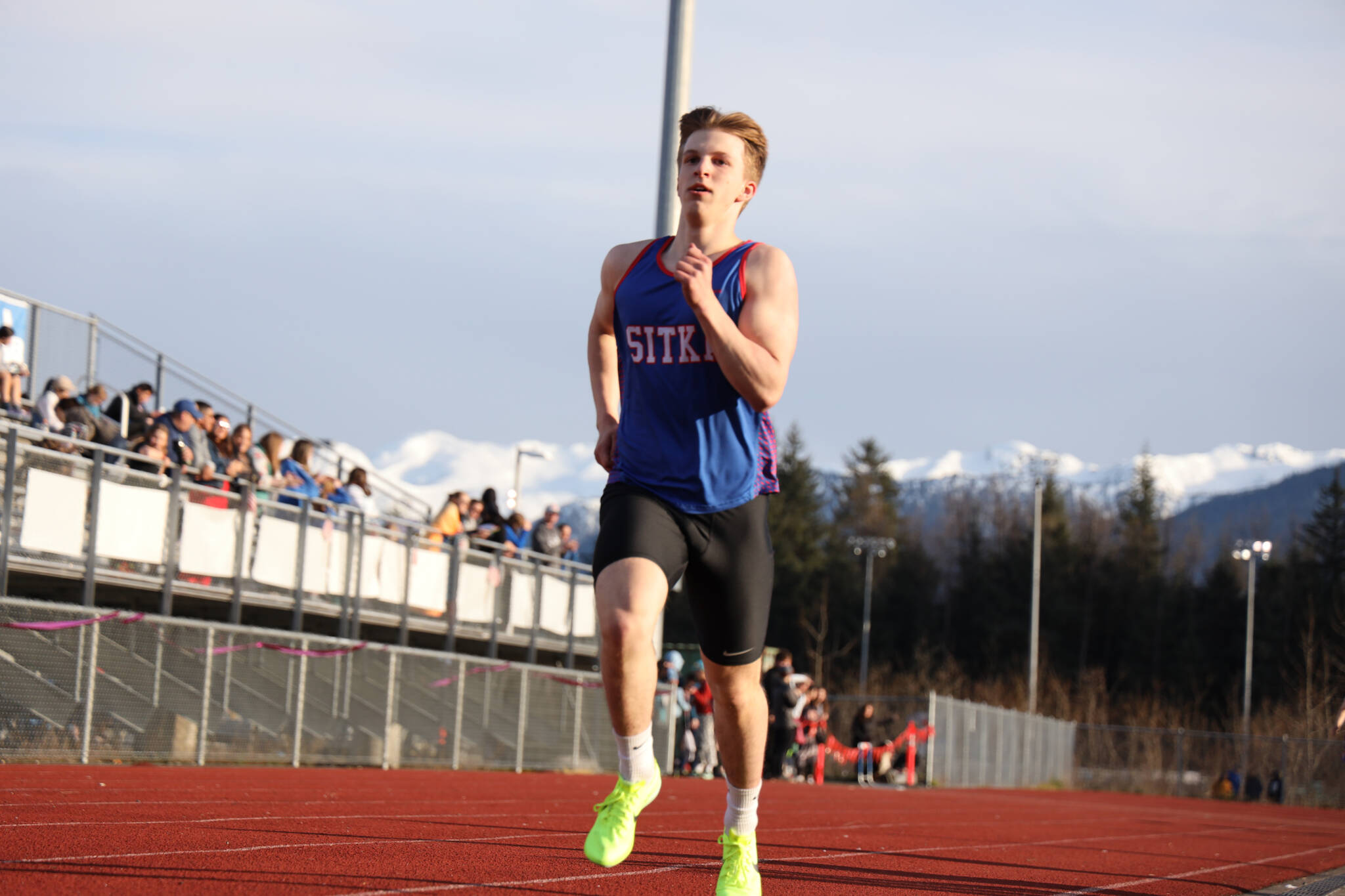Sitka High School senior Silas Demmert sprints to the finish line during the Capital Invitational Track and Field meet Friday evening. (Clarise Larson / Juneau Empire)