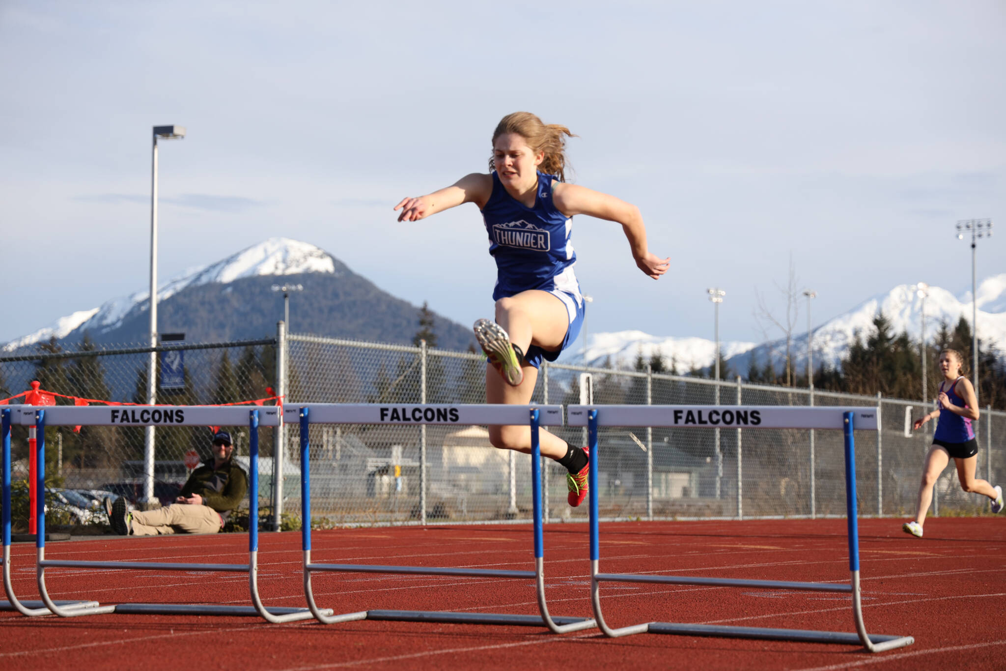 Thunder Mountain High School senior Mallory Welling launches over a hurdle during the 300 meter hurdle prelims at the Capital Invitational Track and Field meet Friday evening. (Clarise Larson / Juneau Empire)