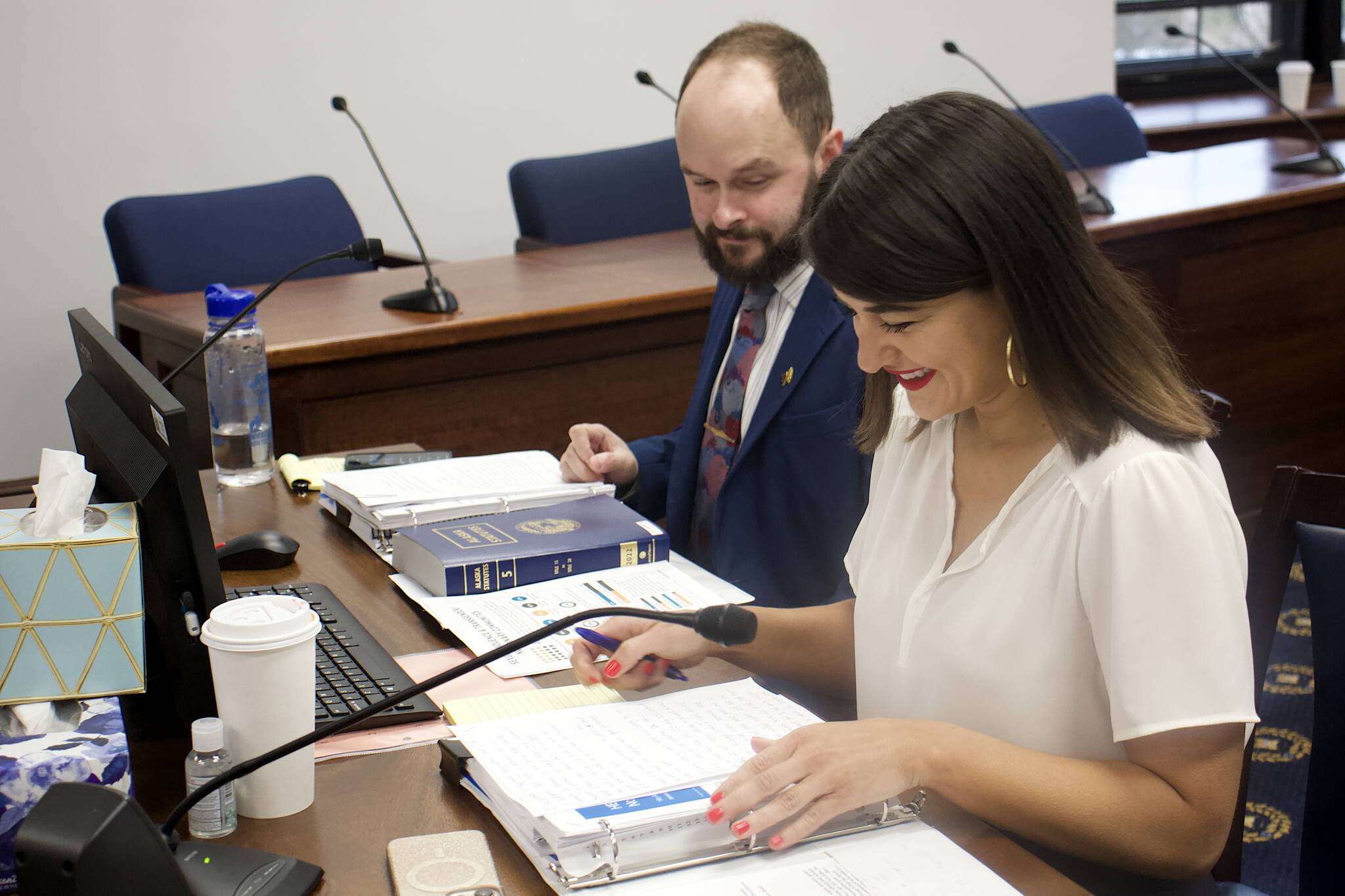 Rep. Jennie Armstrong, D-Anchorage, and Tristin Walsh, a staff member for Armstrong, prepare to present her bill seeking to prevent LGBTQ+ discrimination to the House Community and Regional Affairs Committee on Tuesday. (Mark Sabbatini / Juneau Empire)
