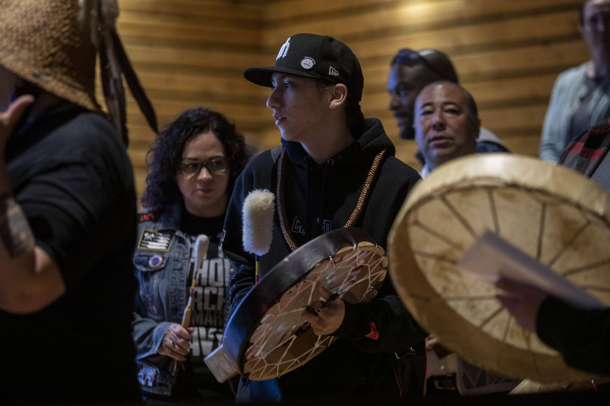 A welcome song is played and sang by Tulalip performers during a Road to Healing event at the Tulalip Gathering Hall in Marysville, Washington on Sunday, April 23, 2023. The tour is lead by United States Secretary of the Interior Deb Haaland and Department of the Interior Assistant Secretary Bryan Newland. (Annie Barker / The Herald)