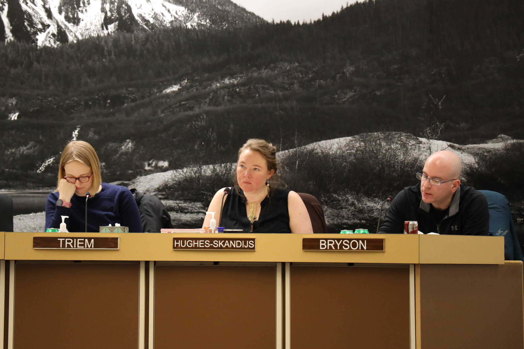 From left to right, City and Borough of Juneau Assembly members Carole Triem, Alicia Hughes-Skandijs and Wade Bryson listen to City Clerk Beth McEwen as she speaks about election code changes Monday night at the Assembly Committee of the Whole meeting where member’s OK’d the city to move an ordinance to make vote-by-mail elections the default in Juneau. (Clarise Larson / Juneau Empire)