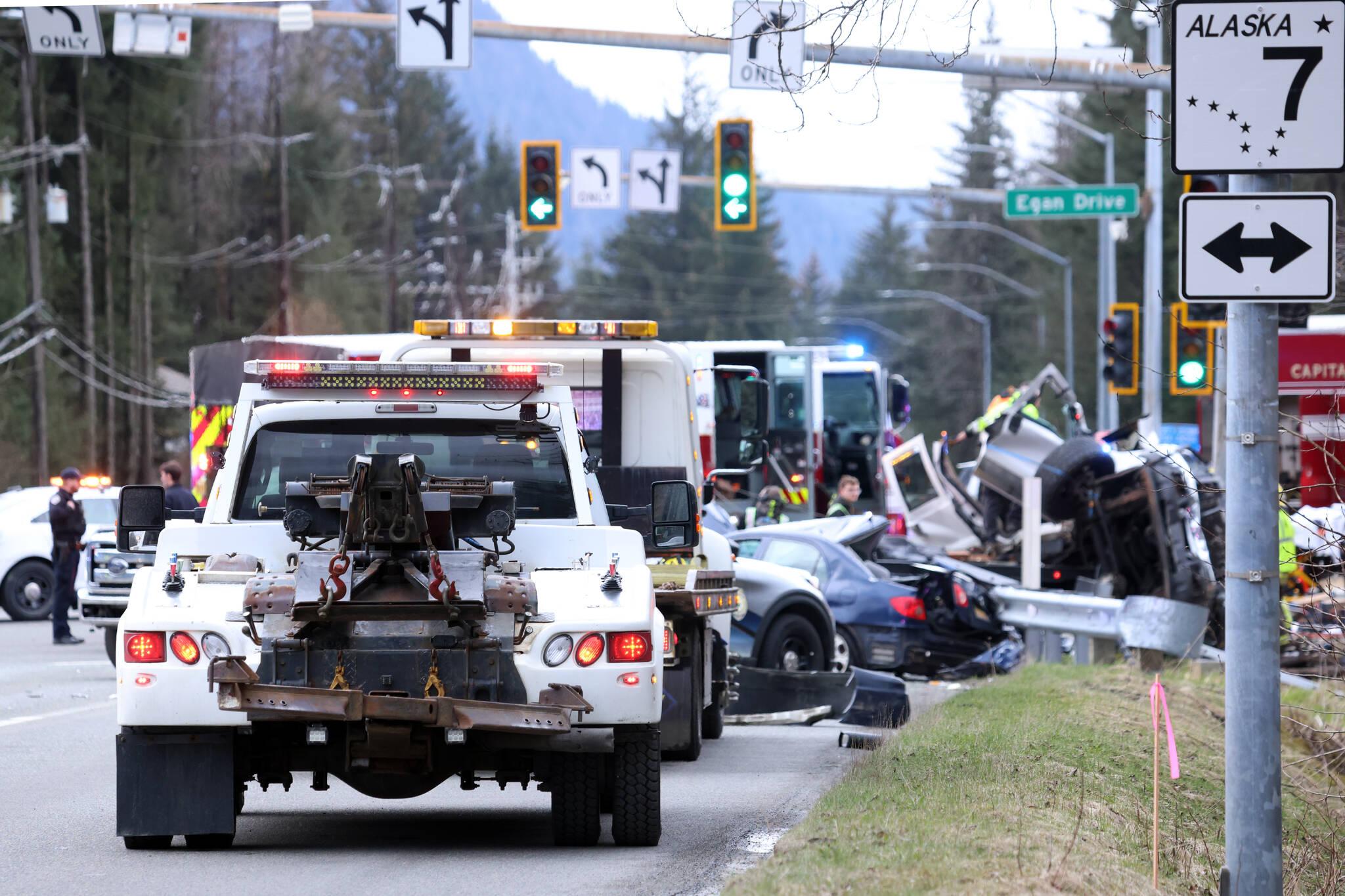 A line of vehicles responds to the scene of a fatal wreck at Egan Drive and Mendenhall Loop Road. The two-vehicle crash involved a car and a truck. Three people in critical condition were taken to the hospital after the wreck, and one person died at the scene, according to Juneau Police Department. (Ben Hohenstatt / Juneau Empire)