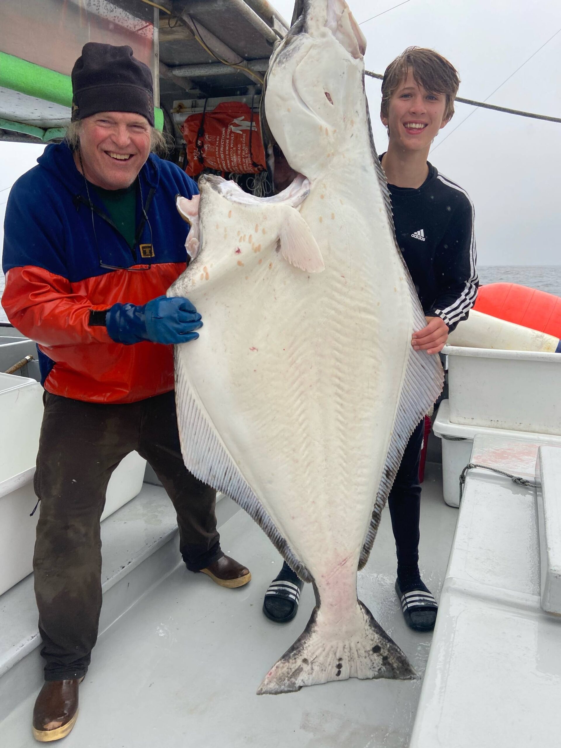 Rise Fraley, a freshman at Juneau-Douglas High School: Yadaa.at Kalé, with Joe Emerson pose for a photo on board the TommyL II with a recently caught fish. Shoreline makes it a point of employing local youth as deckhands as often as possible. (Courtesy Photo / Joe Emerson)