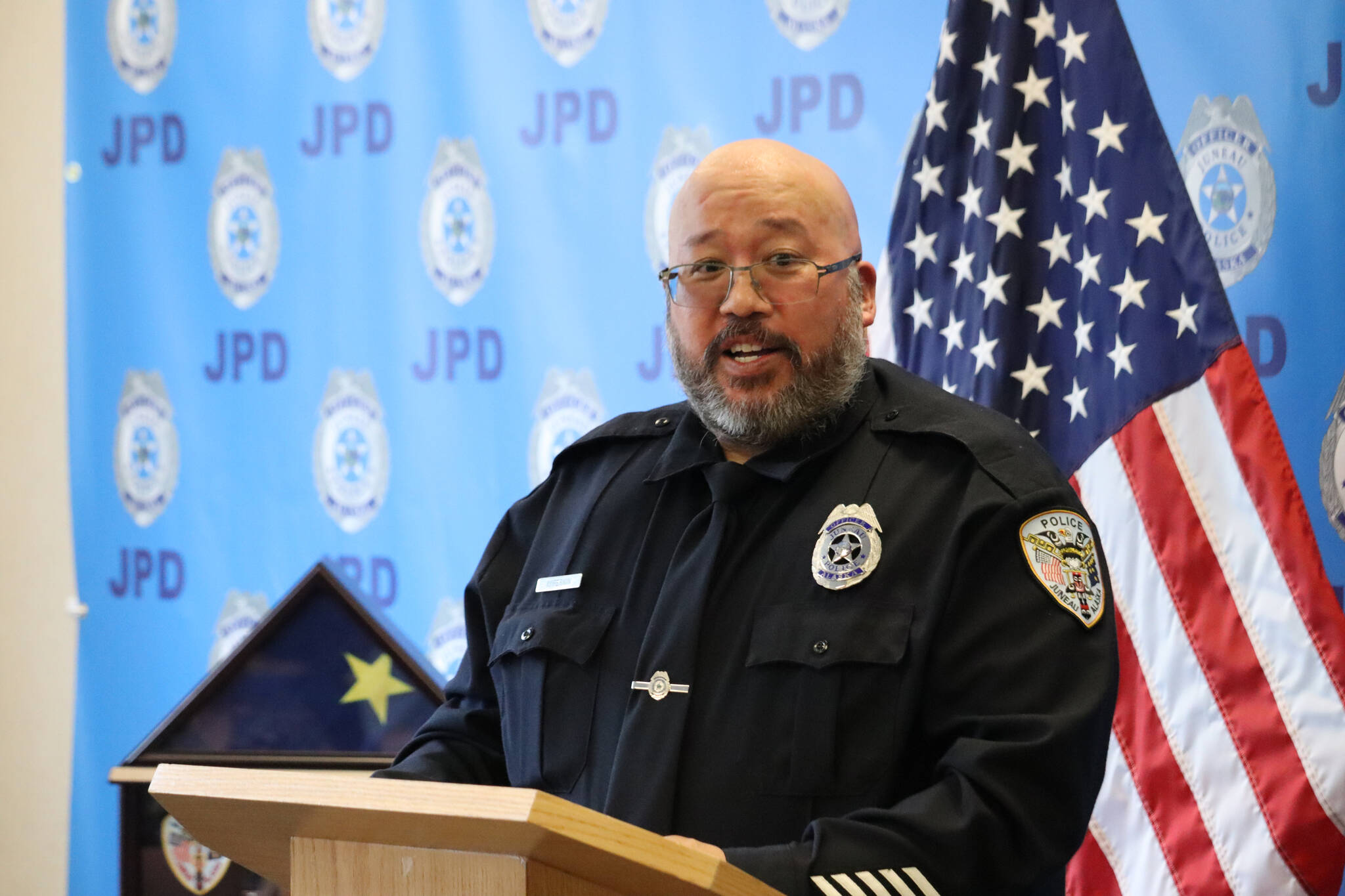 JPD Officer Kevin Fermin speaks from the lectern to friends, colleagues and family members on Friday during his retirement ceremony at the Juneau Police Station. Fermin retires after serving 25 years with JPD. (Jonson Kuhn / Juneau Empire)