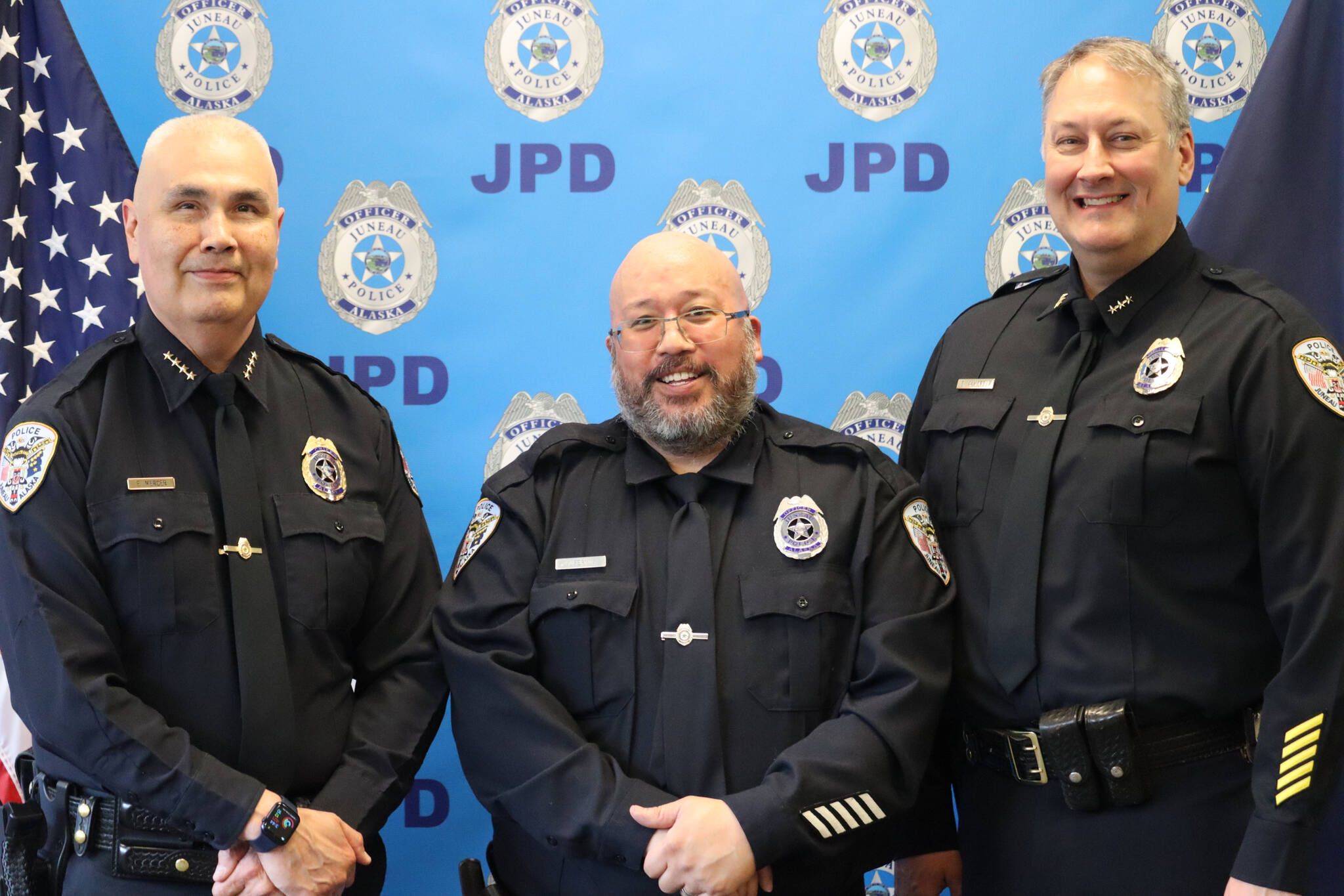 JPD Chief Ed Mercer, Officer Kevin Fermin and Deputy Chief David Campbell pose for a group photo on Friday during Fermin’s retirement ceremony at the Juneau Police Department. (Jonson Kuhn / Juneau Empire)