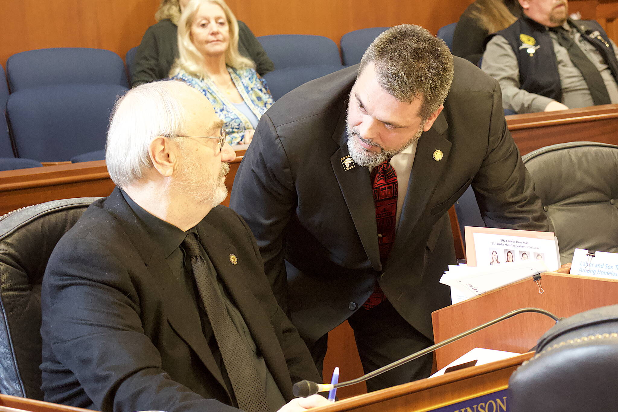 State Rep. Mike Cronk, R-Tok, left, confers with Rep. Craig Johnson, during floor debate Wednesday about a bill prohibiting state and local governments from imposing firearms restrictions during disaster declarations. (Mark Sabbatini / Juneau Empire)