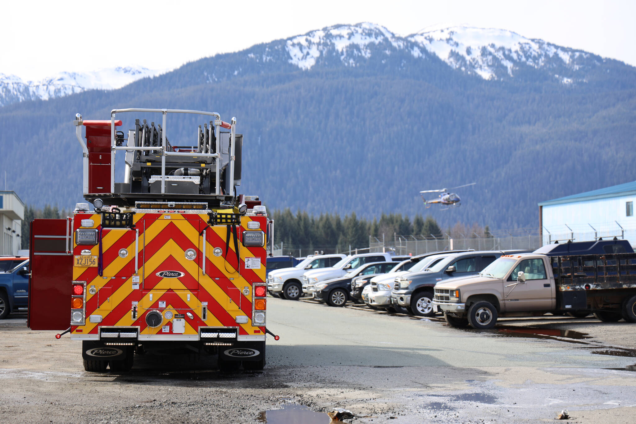 A Capital City Fire/Rescue truck parks near a privately owned airport hangar at the Juneau International Airport after Capital City Fire/Rescue extinguished a fire in the building Thursday morning. (Clarise Larson / Juneau Empire)